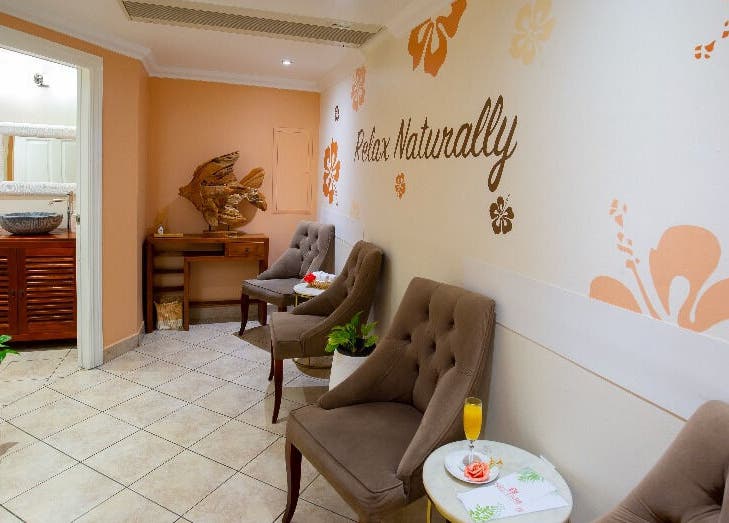 Relaxing seating area at NECTAR Spa OBBR, Oyster Bay, SX with plush chairs and chic decor.