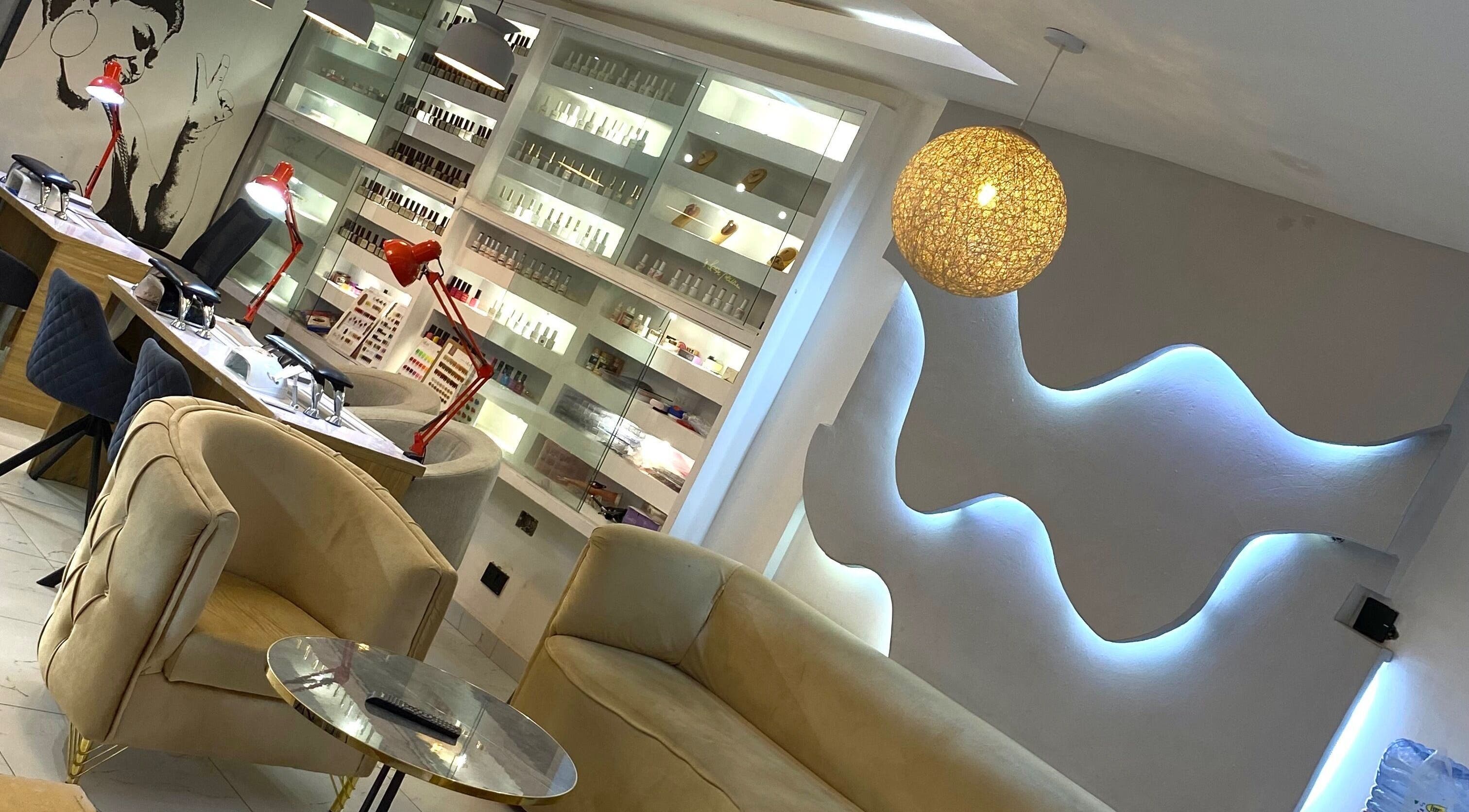 Modern interior of Everything Nails & Spa in Accra, showcasing chic seating and elegant lighting.