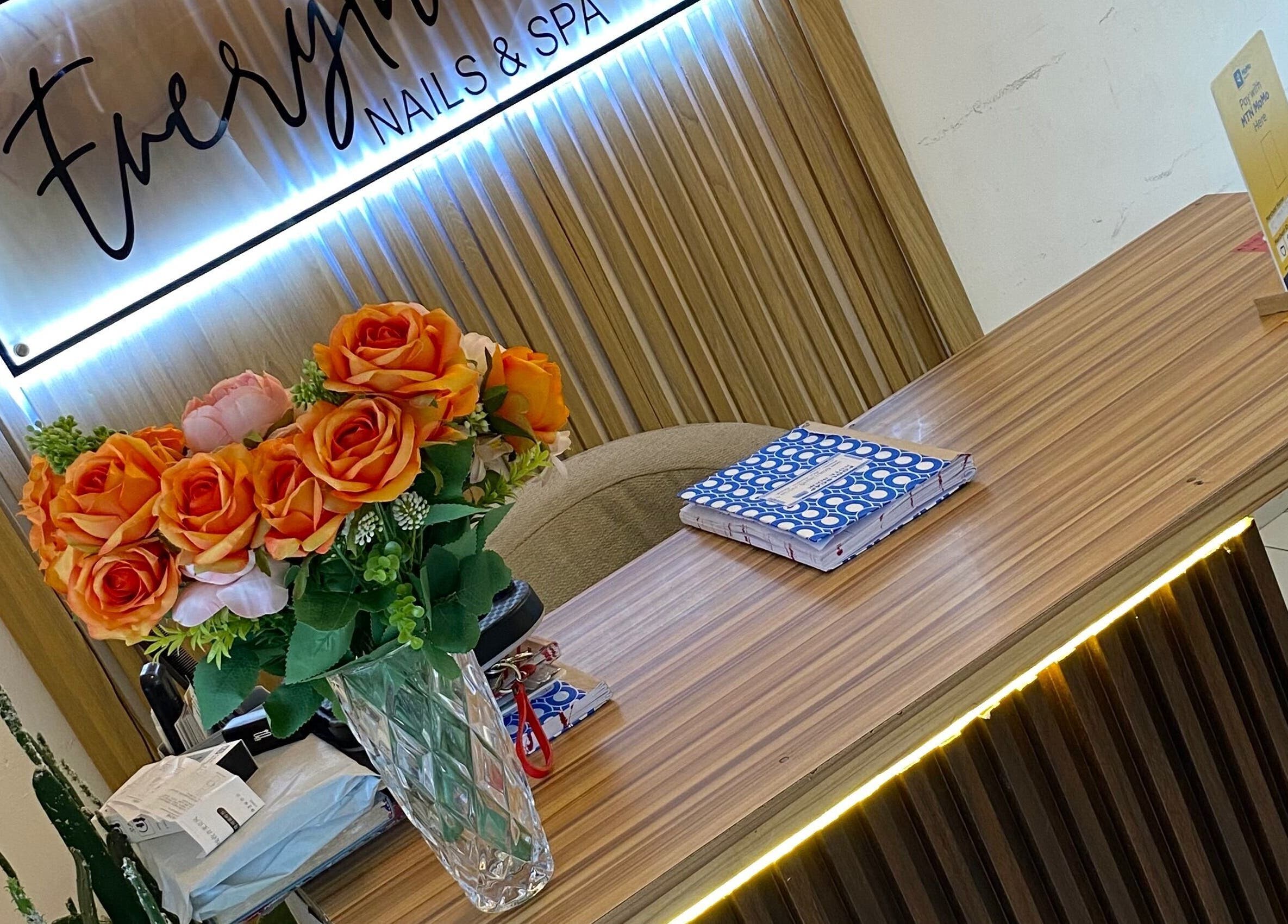 Reception area at Everything Nails & Spa, Accra, Greater Accra Region, GH, adorned with vibrant flowers.