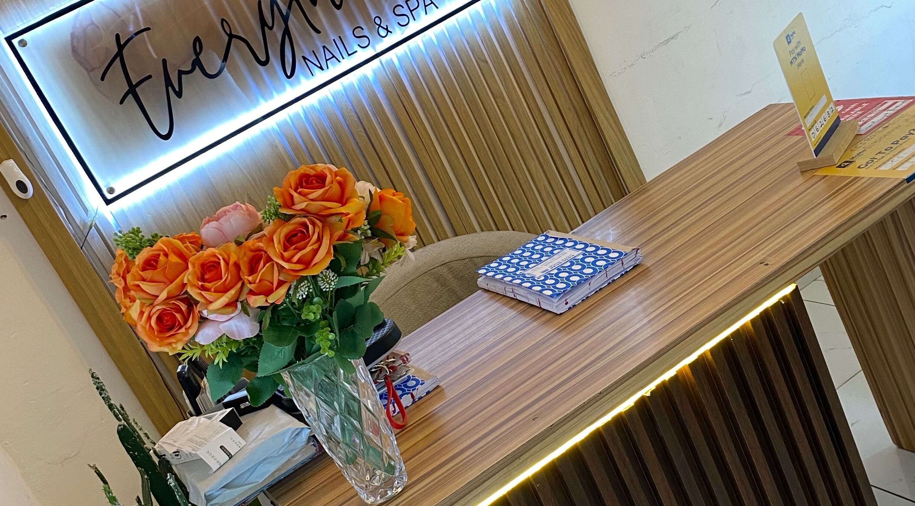 Reception area at Everything Nails & Spa, Accra, Greater Accra Region, GH, adorned with vibrant flowers.