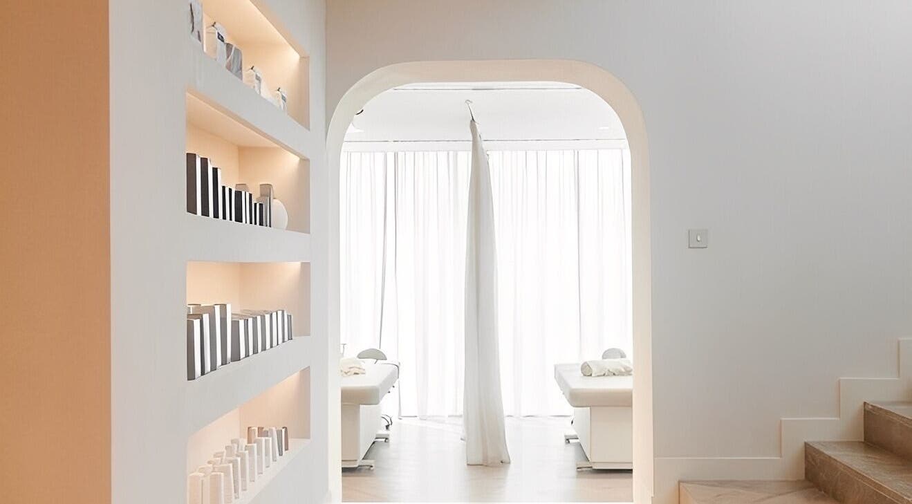 Calm, minimalist treatment room at BaharBrows in Dubai, Dubai, AE with light-filled space and sleek shelves.