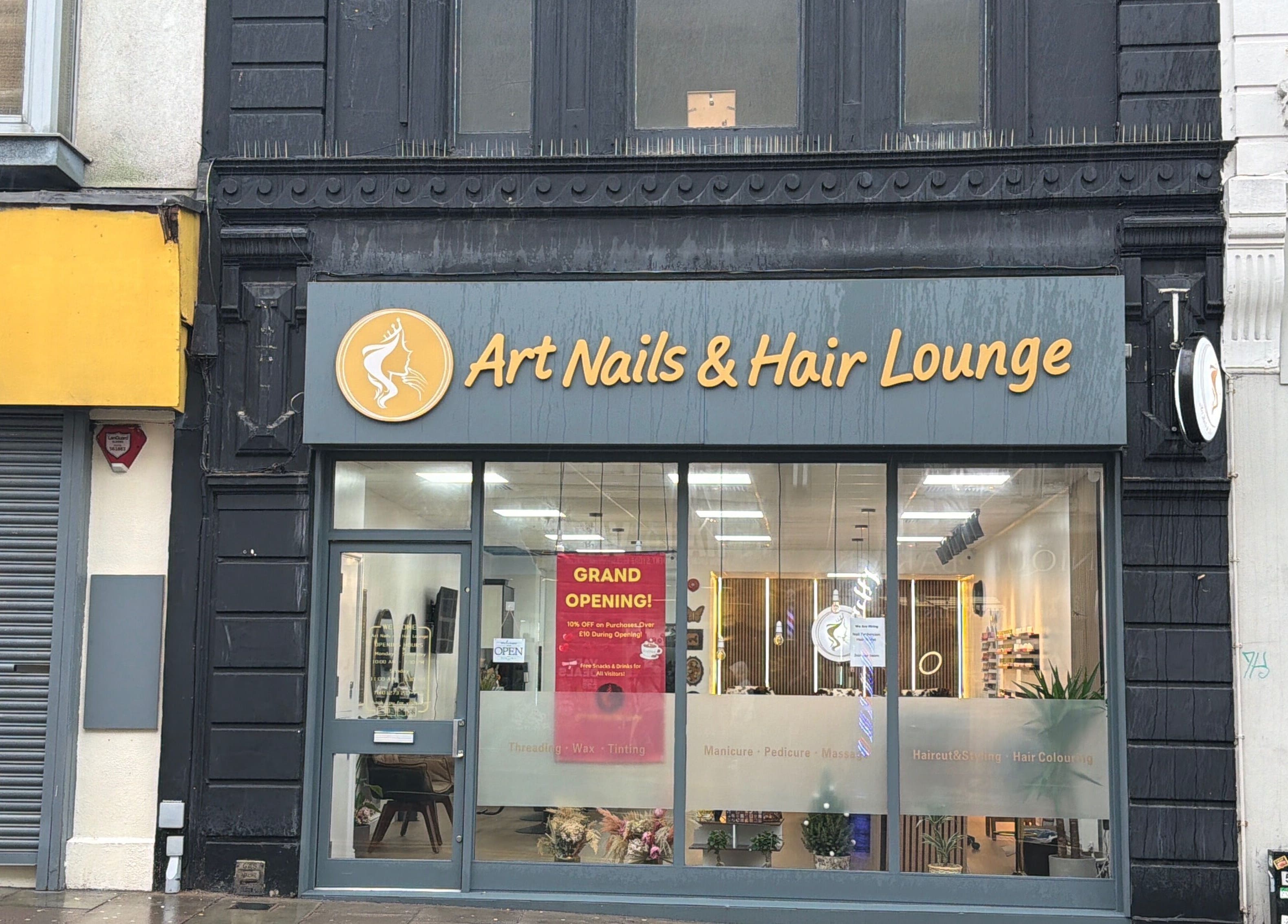 Exterior of Art Nails&Hair Lounge in Brighton And Hove, England, featuring grand opening signage.