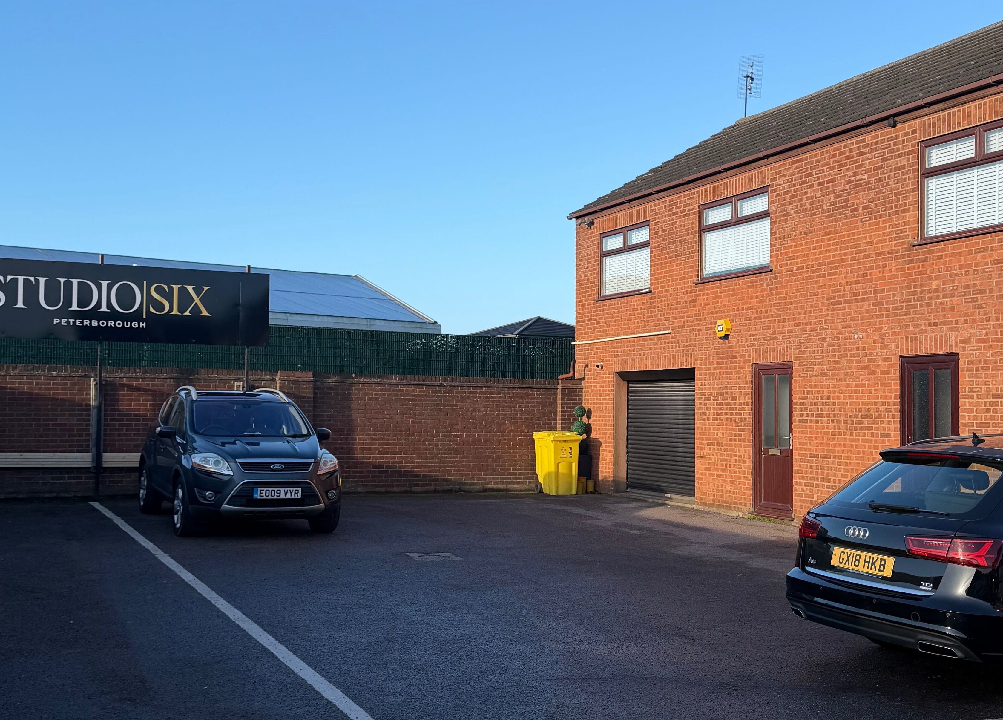 Exterior view of Reve Wellness Clinic in Peterborough, England, GB featuring parking area and signage.