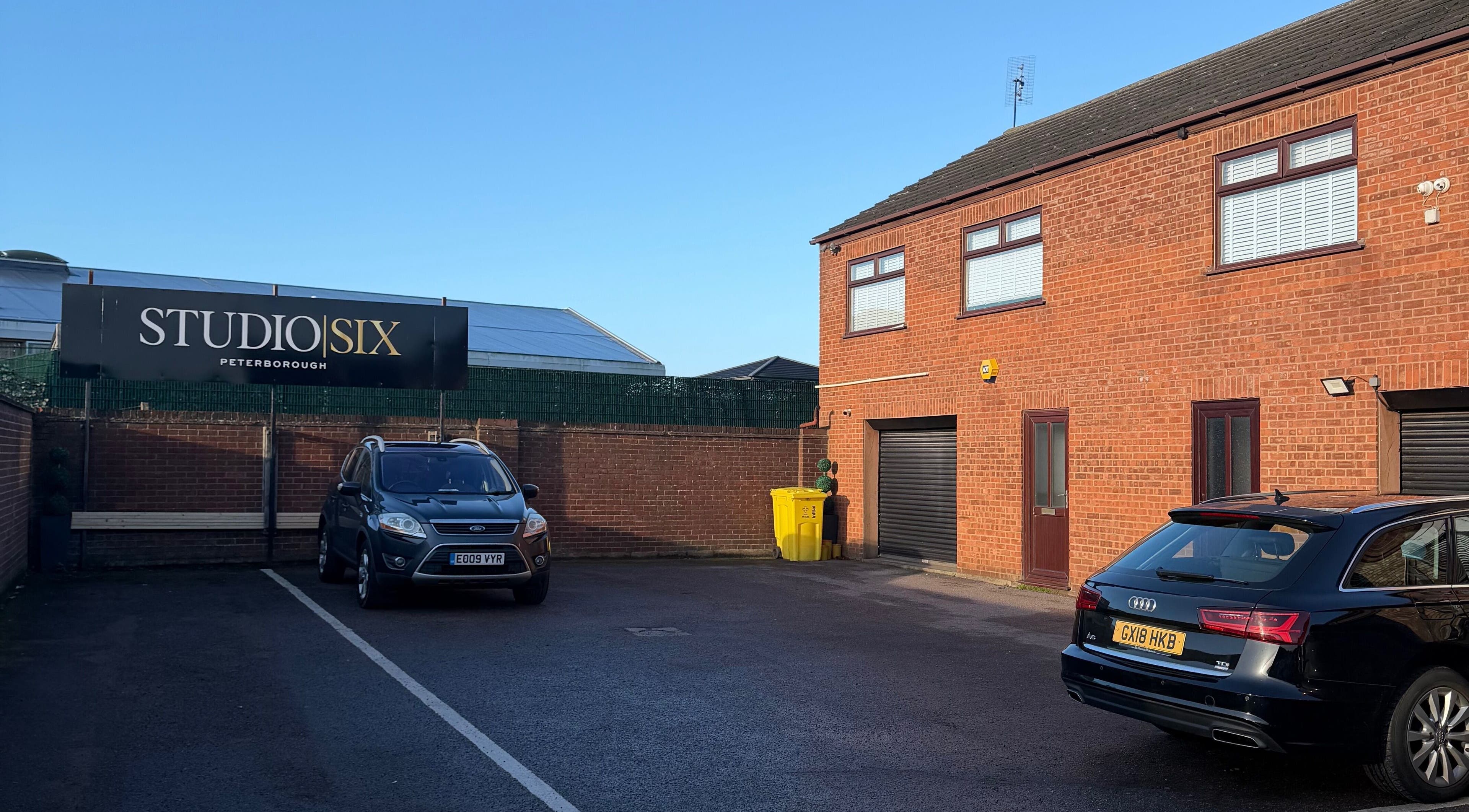Exterior view of Reve Wellness Clinic in Peterborough, England, GB featuring parking area and signage.