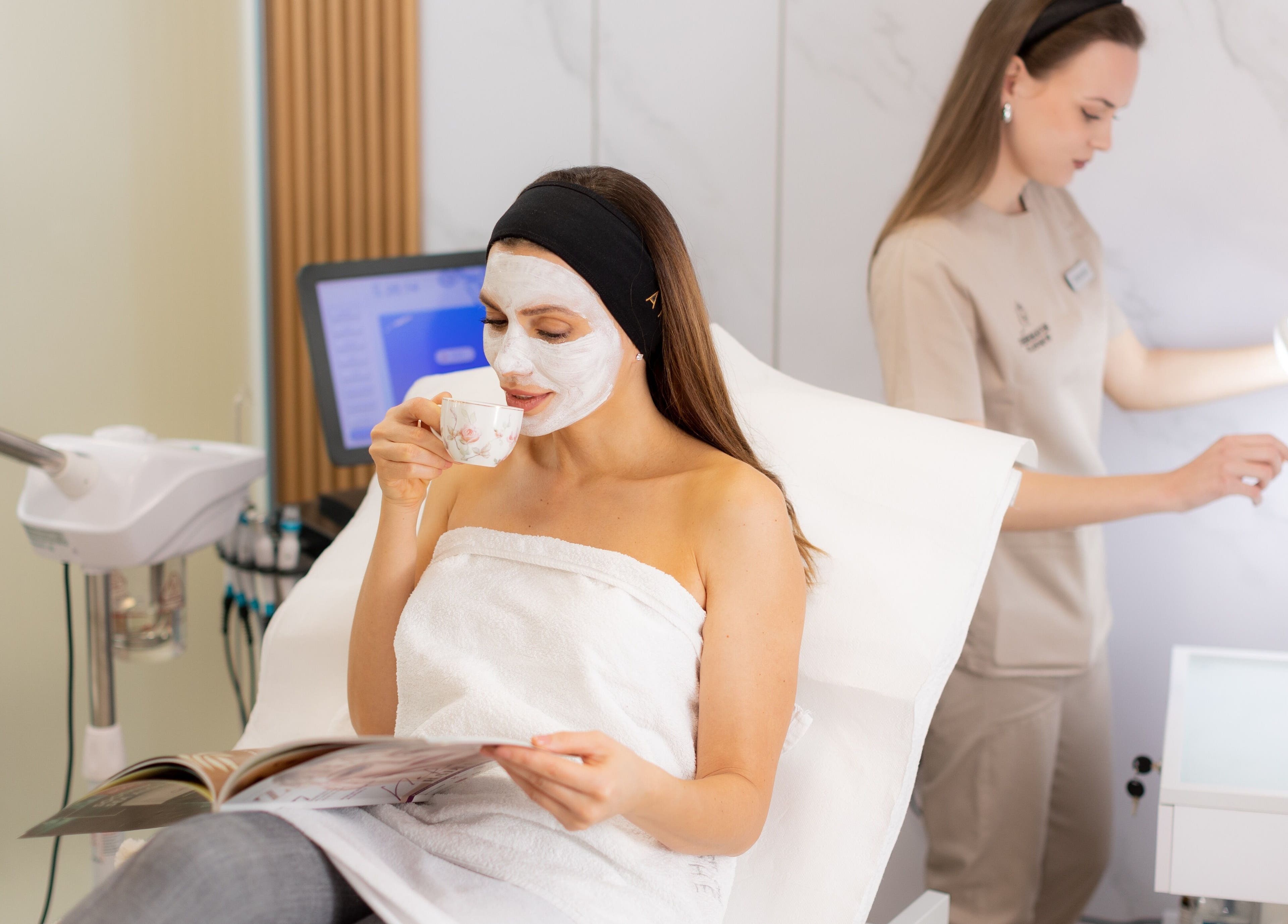 Client enjoying facial treatment with a drink at Dermavie Clinique, Novi Sad, Vojvodina, RS.