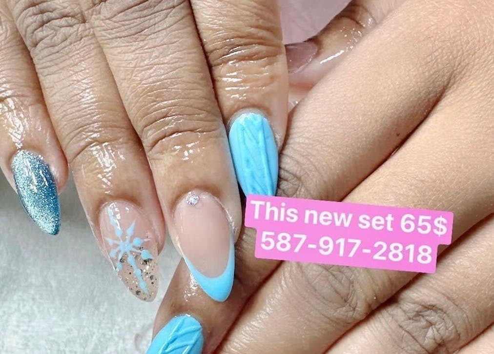 Elegant frosty nail design at Nails By Hannah Le, Calgary, Alberta, CA featuring glitter and snowflakes.