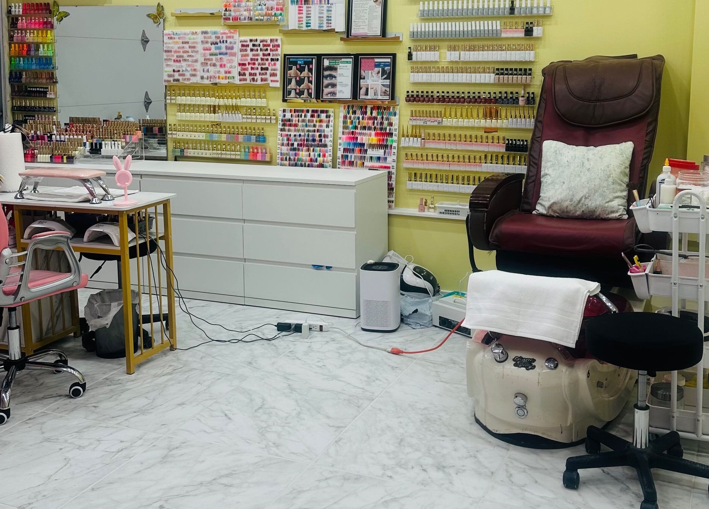 Chic nail studio at Nails By Hannah Le in Calgary, Alberta, CA, showcasing vibrant polish selection and cozy pedicure chair.