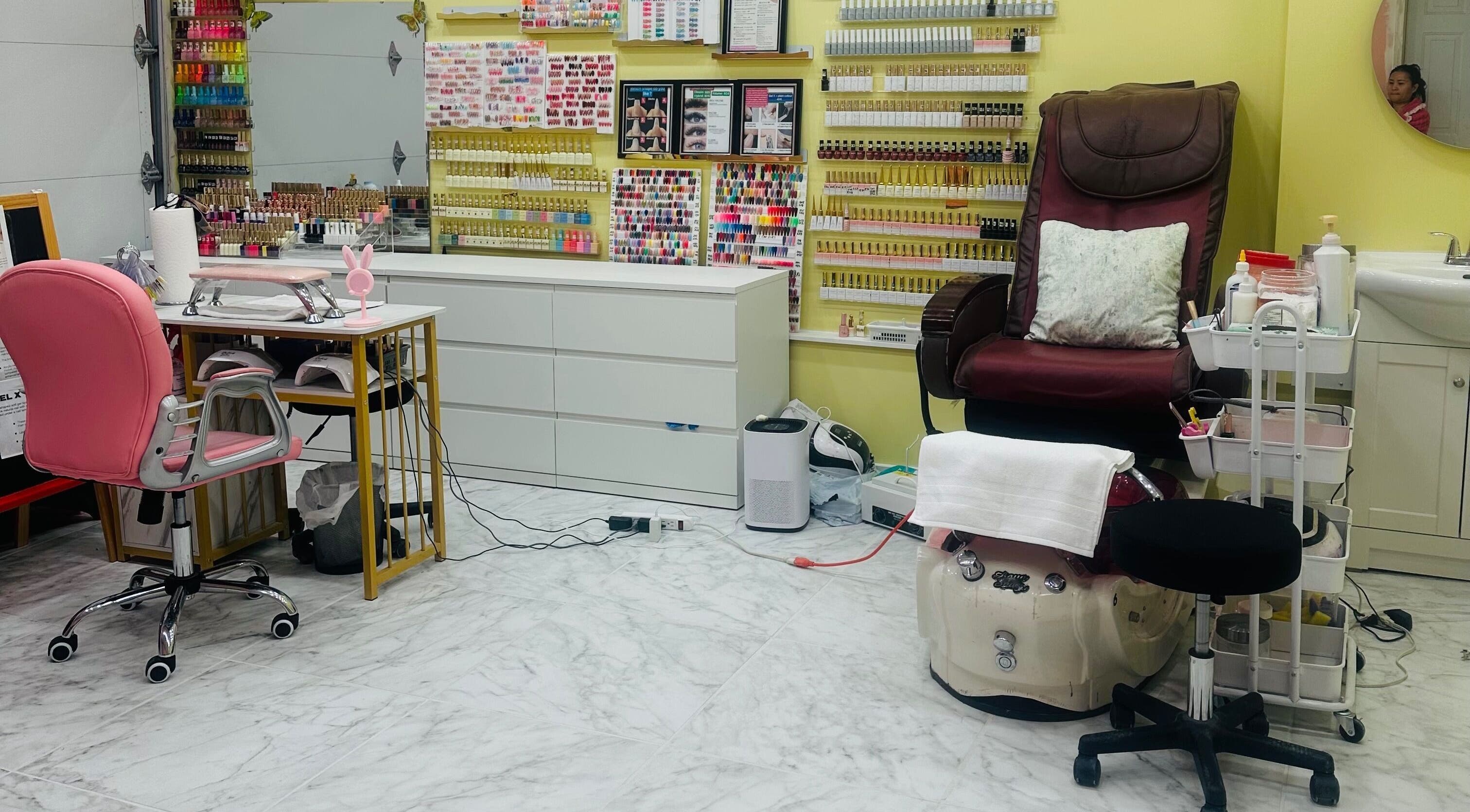 Chic nail studio at Nails By Hannah Le in Calgary, Alberta, CA, showcasing vibrant polish selection and cozy pedicure chair.