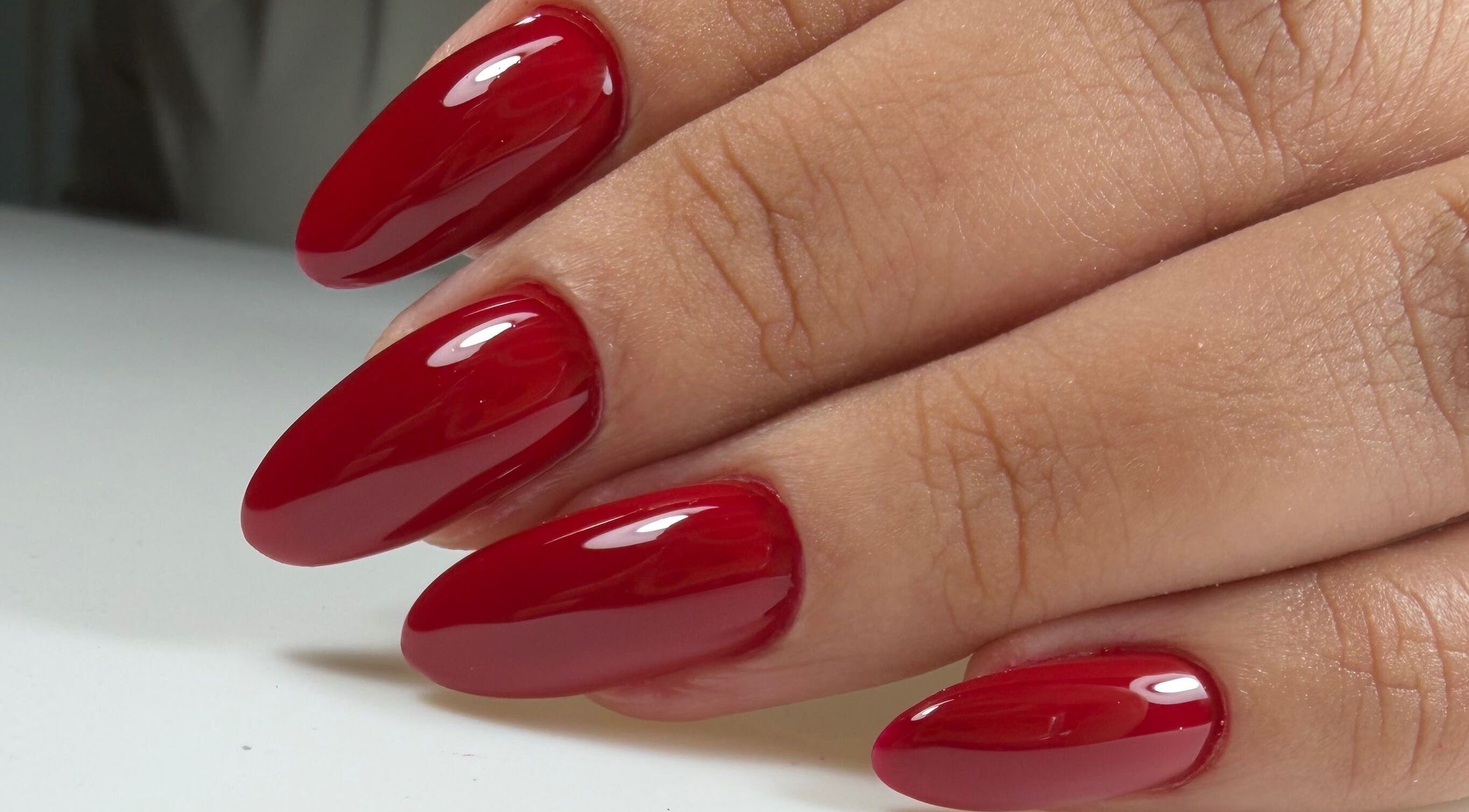Glossy red manicure by Ana's Nails Studio, located in Paramaribo, Paramaribo, SR, showcasing elegant nail art.
