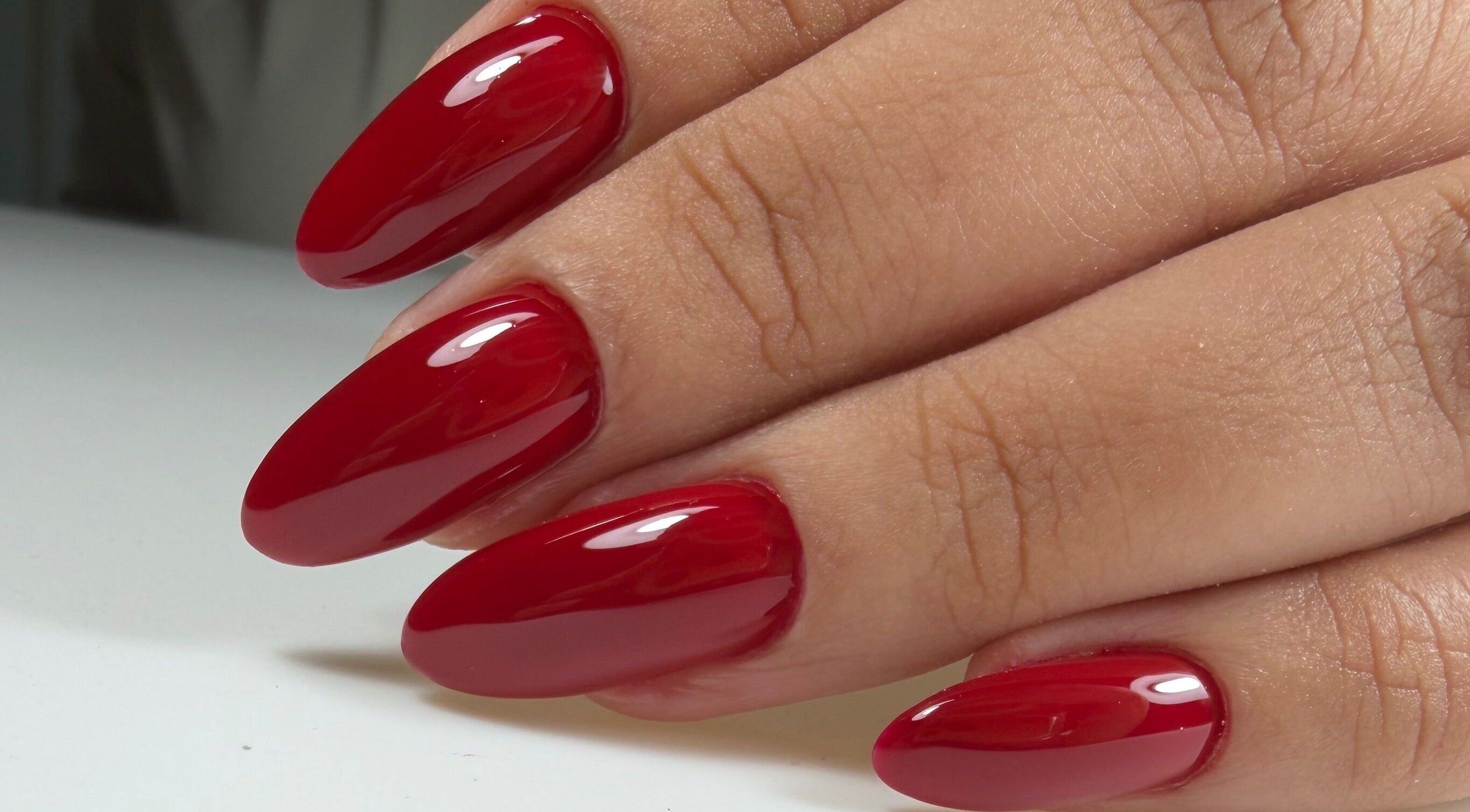 Glossy red manicure by Ana's Nails Studio, located in Paramaribo, Paramaribo, SR, showcasing elegant nail art.
