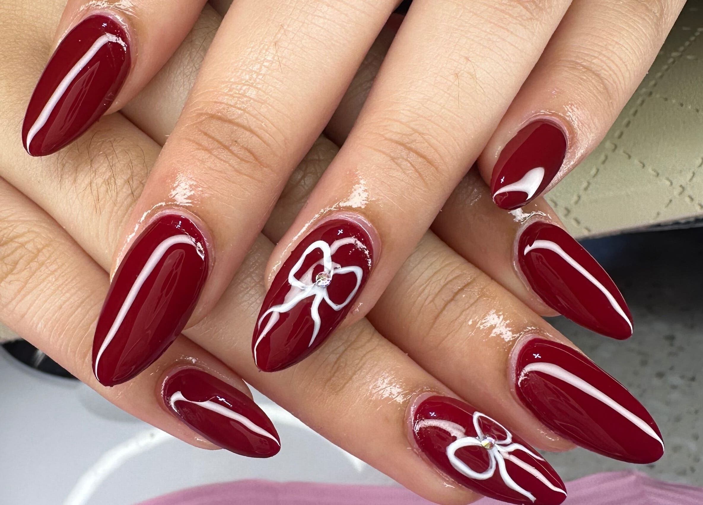 Stunning nail art with deep red polish at Aleya's Infinite Glow in Paramaribo, Paramaribo, SR.