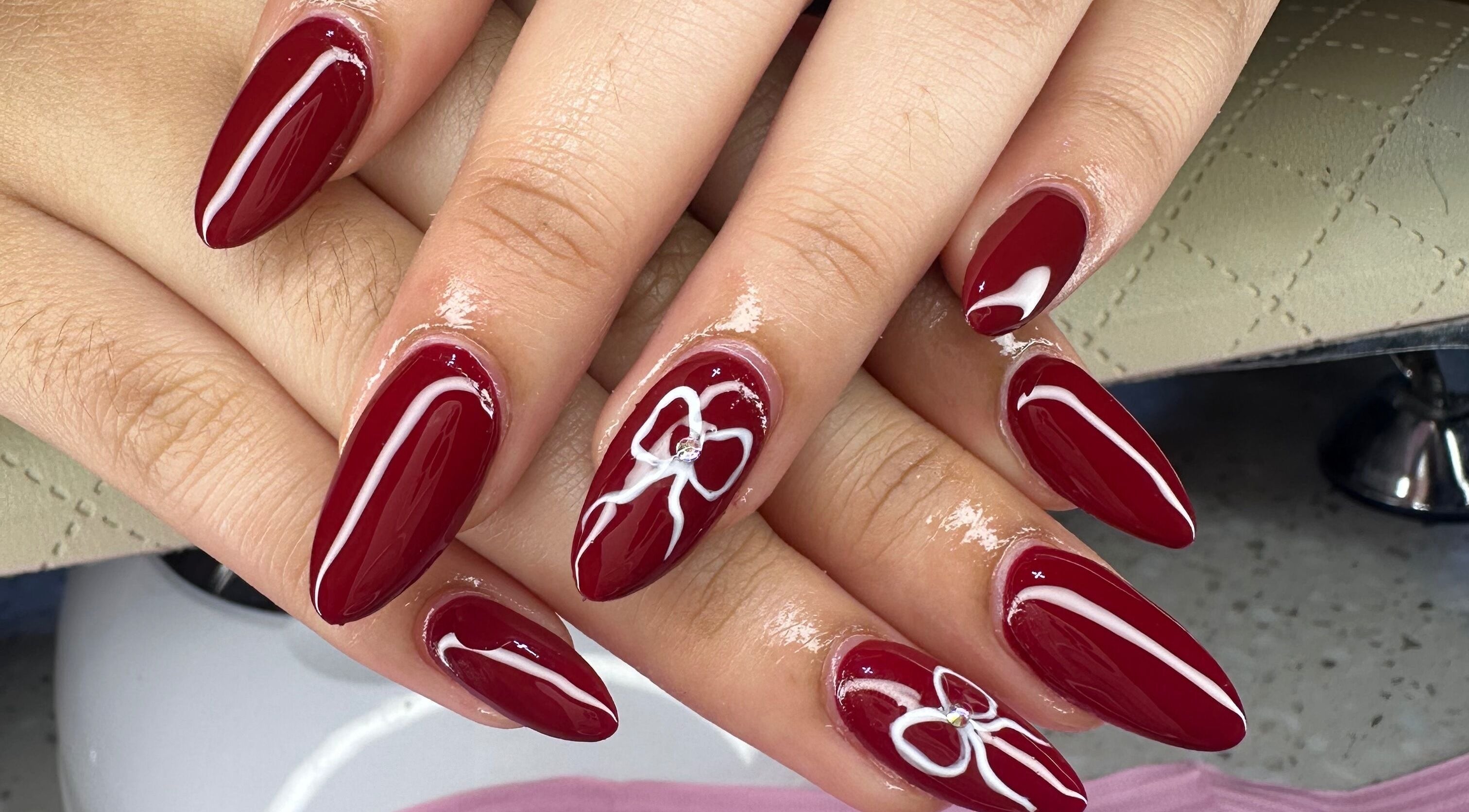 Stunning nail art with deep red polish at Aleya's Infinite Glow in Paramaribo, Paramaribo, SR.