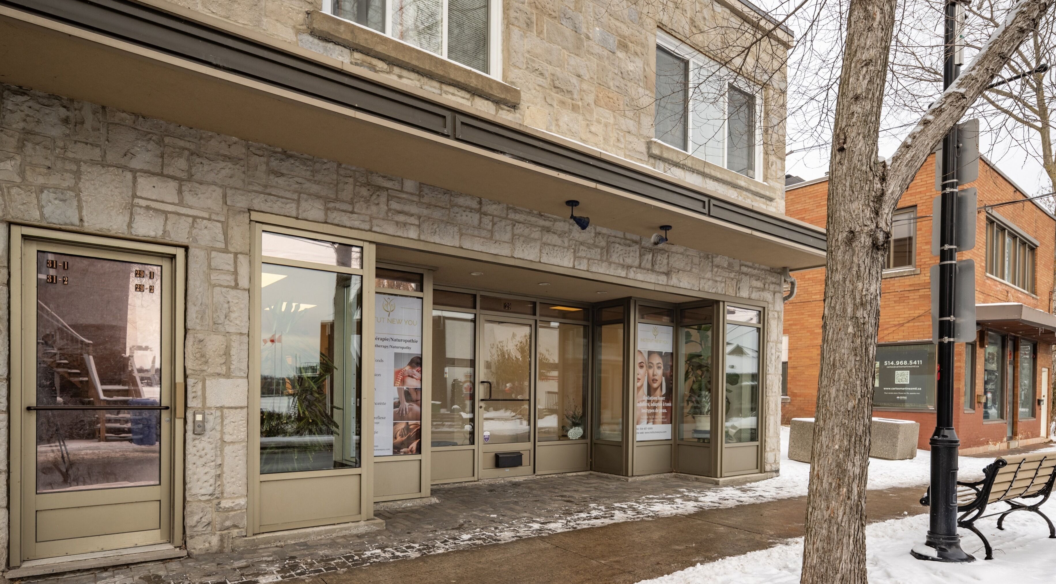 Exterior view of Institut NewYou in Sainte-Anne-de-Bellevue, Québec, CA. Modern stone building entrance.