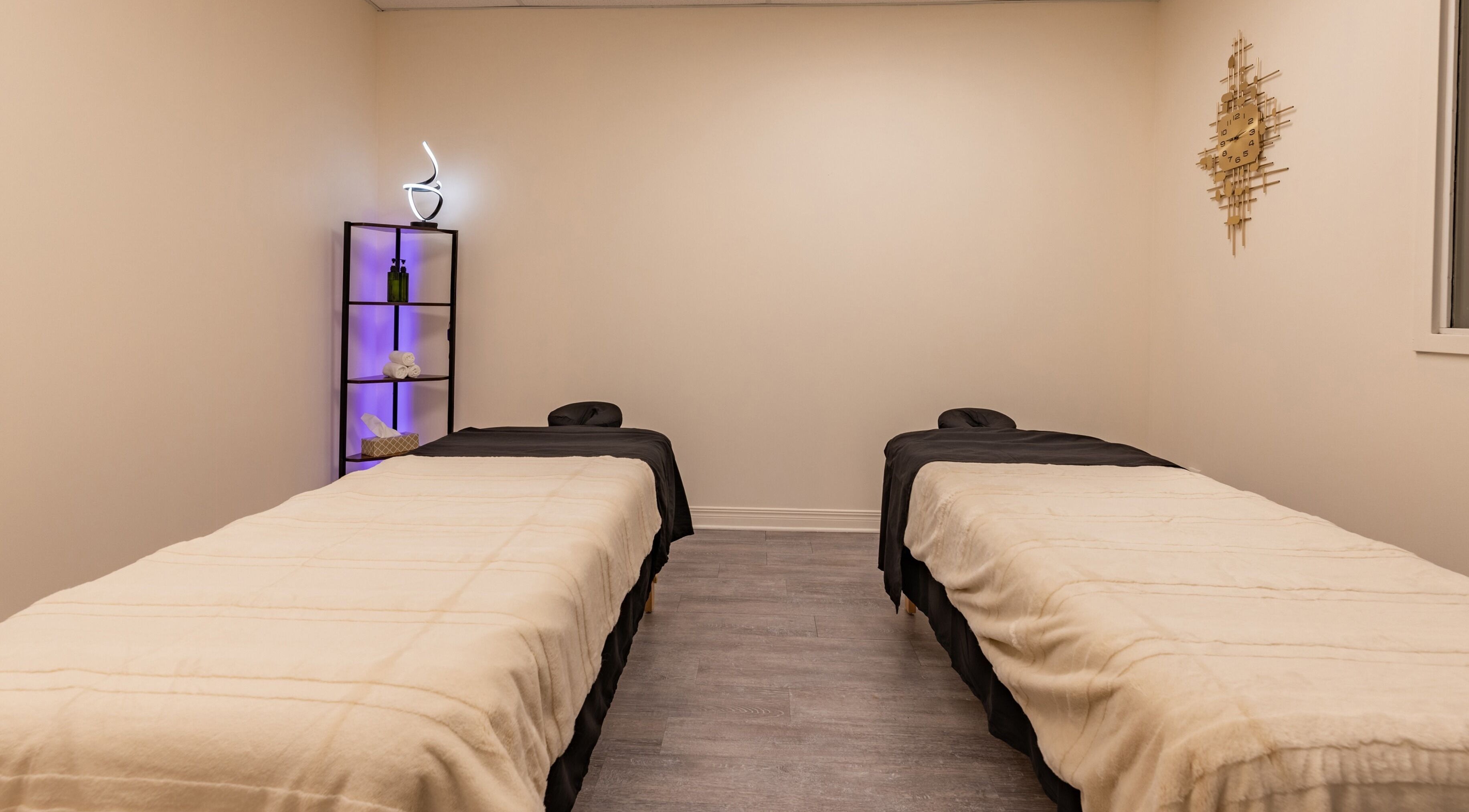 Twin massage tables in a calm room at Institut NewYou, Sainte-Anne-de-Bellevue, Québec, CA.