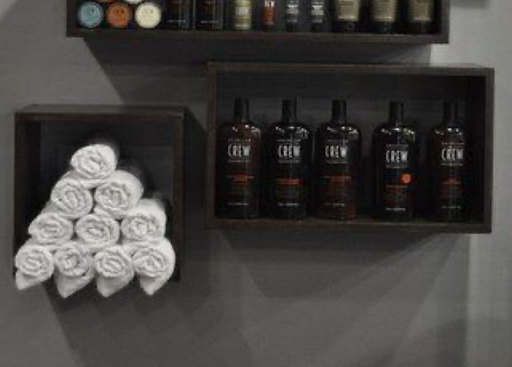 Elegant product display at THE BARBER ONE in San Andrés Cholula, Puebla, MX featuring hair products and towels.