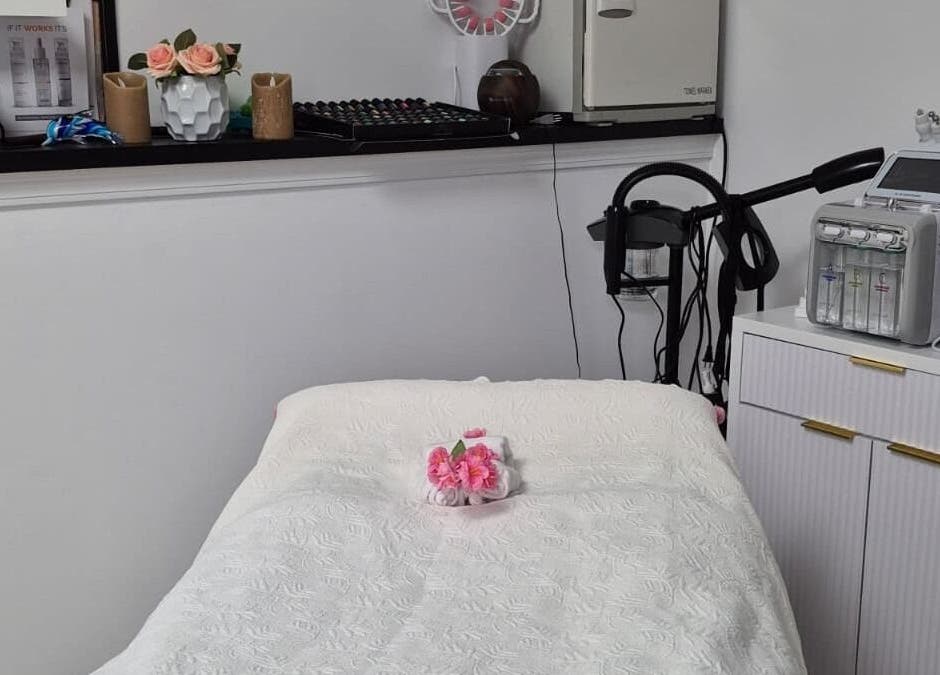 Cozy spa room with plush bed at Dubai Lux Spa, Barnstable, Massachusetts, US, adorned with pink flowers.