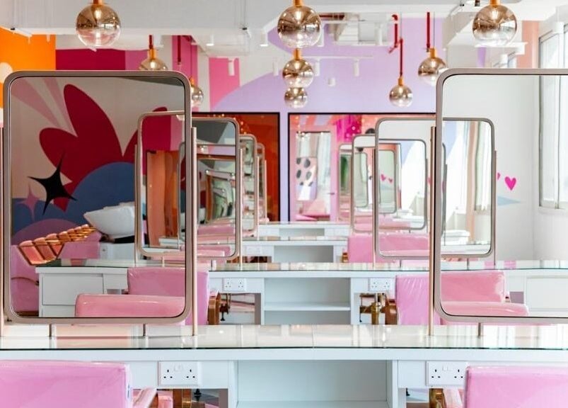 Pretty Wow salon interior with chic decor and pink chairs in Dubai, Dubai, AE.