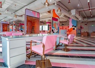 Chic interior of Pretty Wow in Dubai, Dubai, AE with pink decor and stylish chairs.