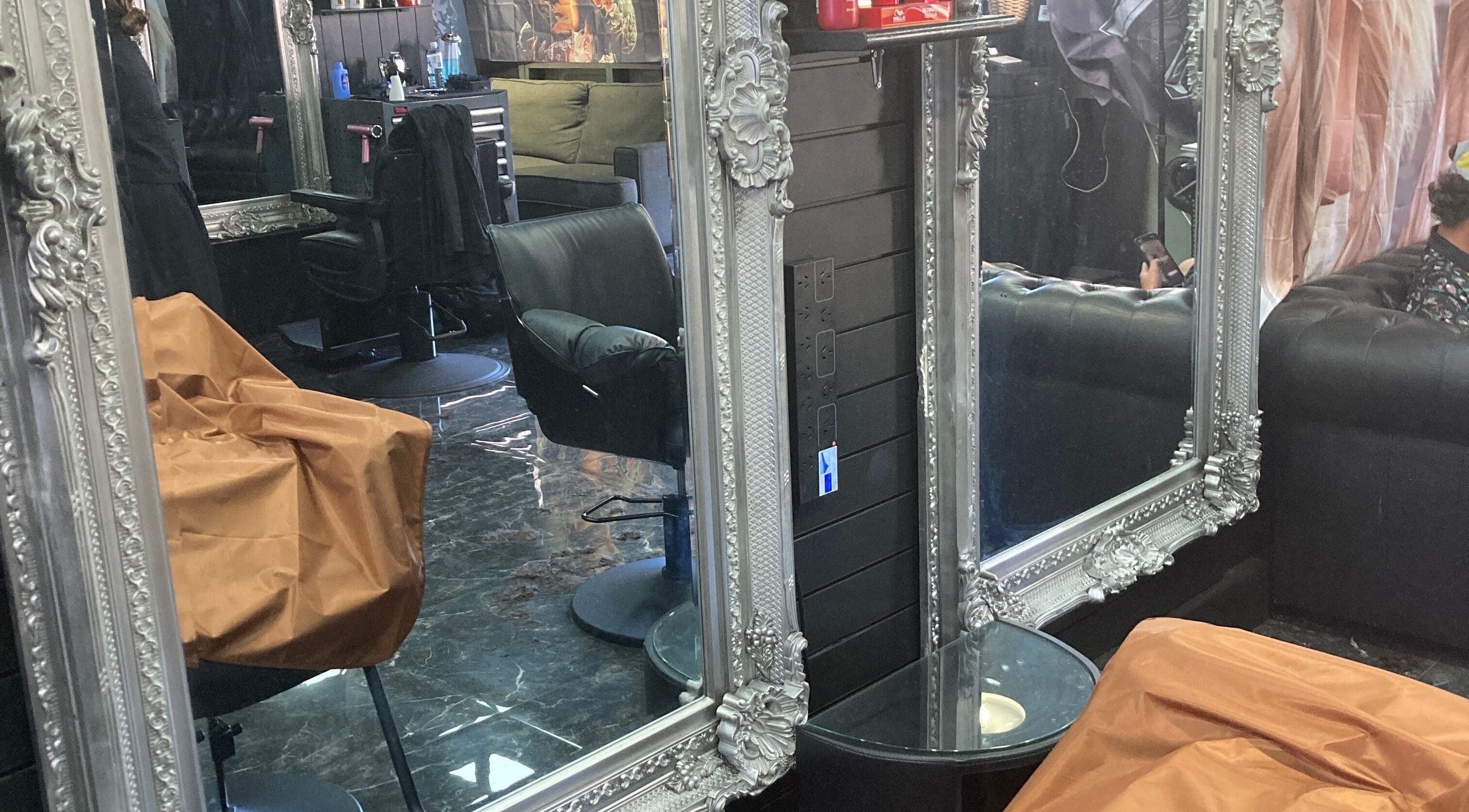 Chic interior of MGP Salon in Nickol, Western Australia featuring ornate mirrors and modern chairs.