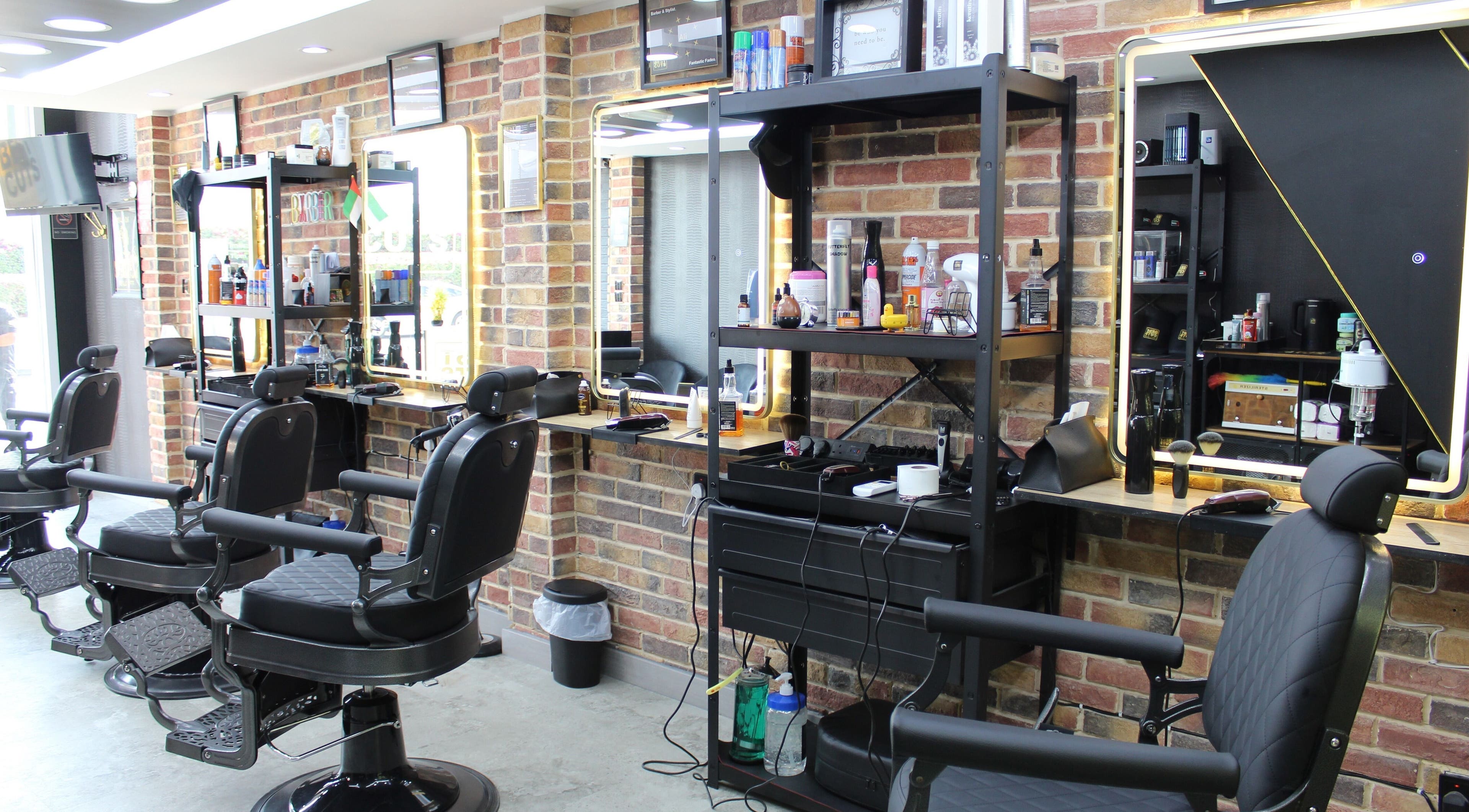 Stylish interior of Best Cuts Gents Salon in Dubai, Dubai, AE with barber chairs and grooming products.
