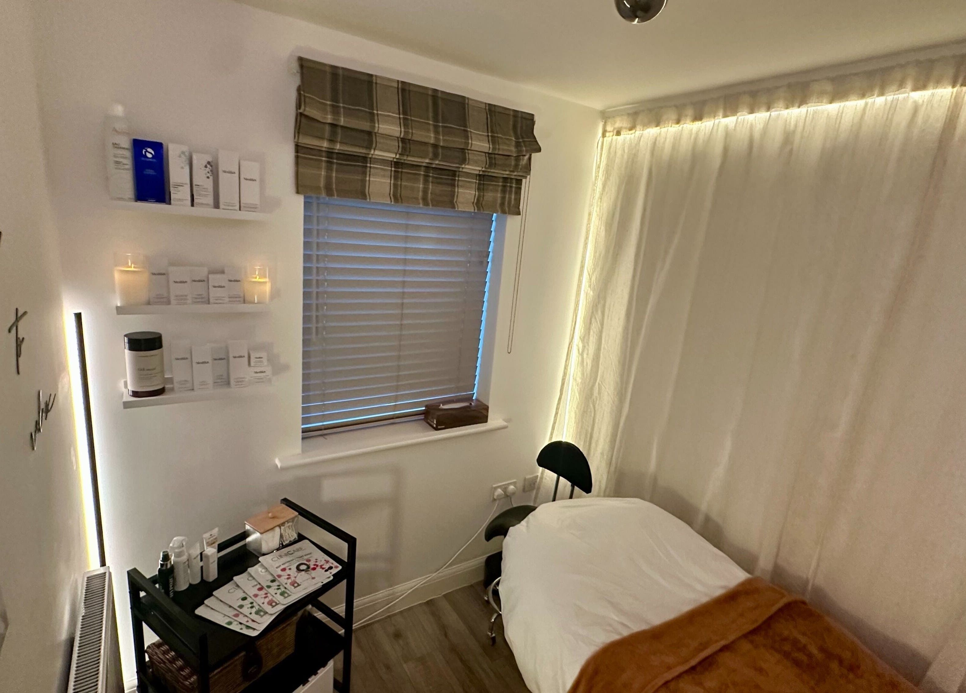 Cozy skincare room at The Skincare Snug, Yate, England, GB, featuring treatment bed and products.