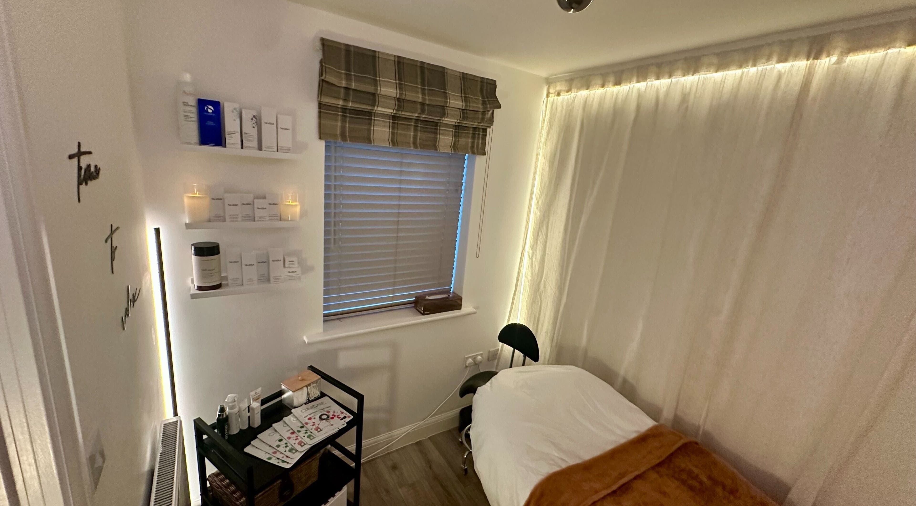 Cozy skincare room at The Skincare Snug, Yate, England, GB, featuring treatment bed and products.