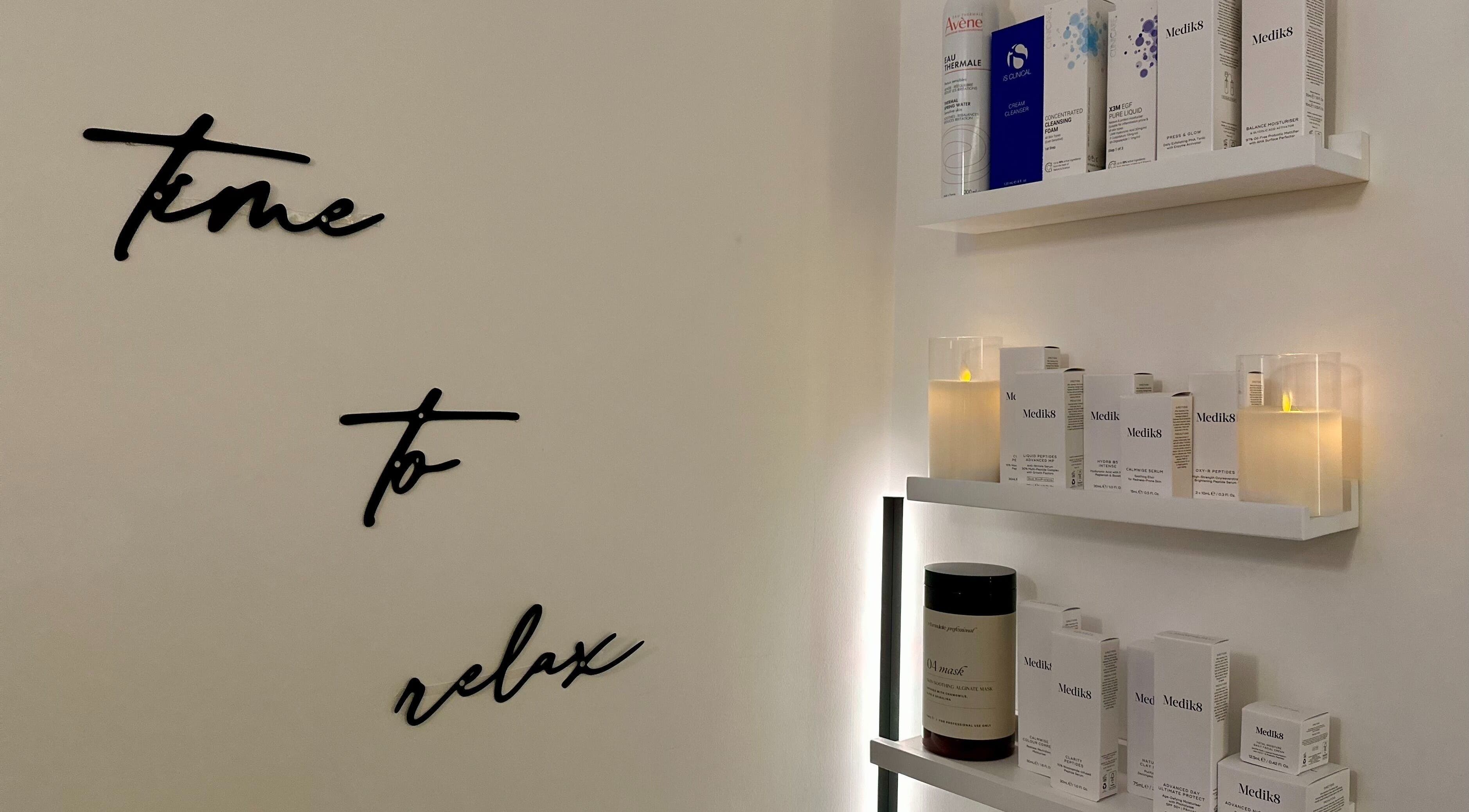 The Skincare Snug in Yate, England, GB: serene shelves with candles and skincare products.