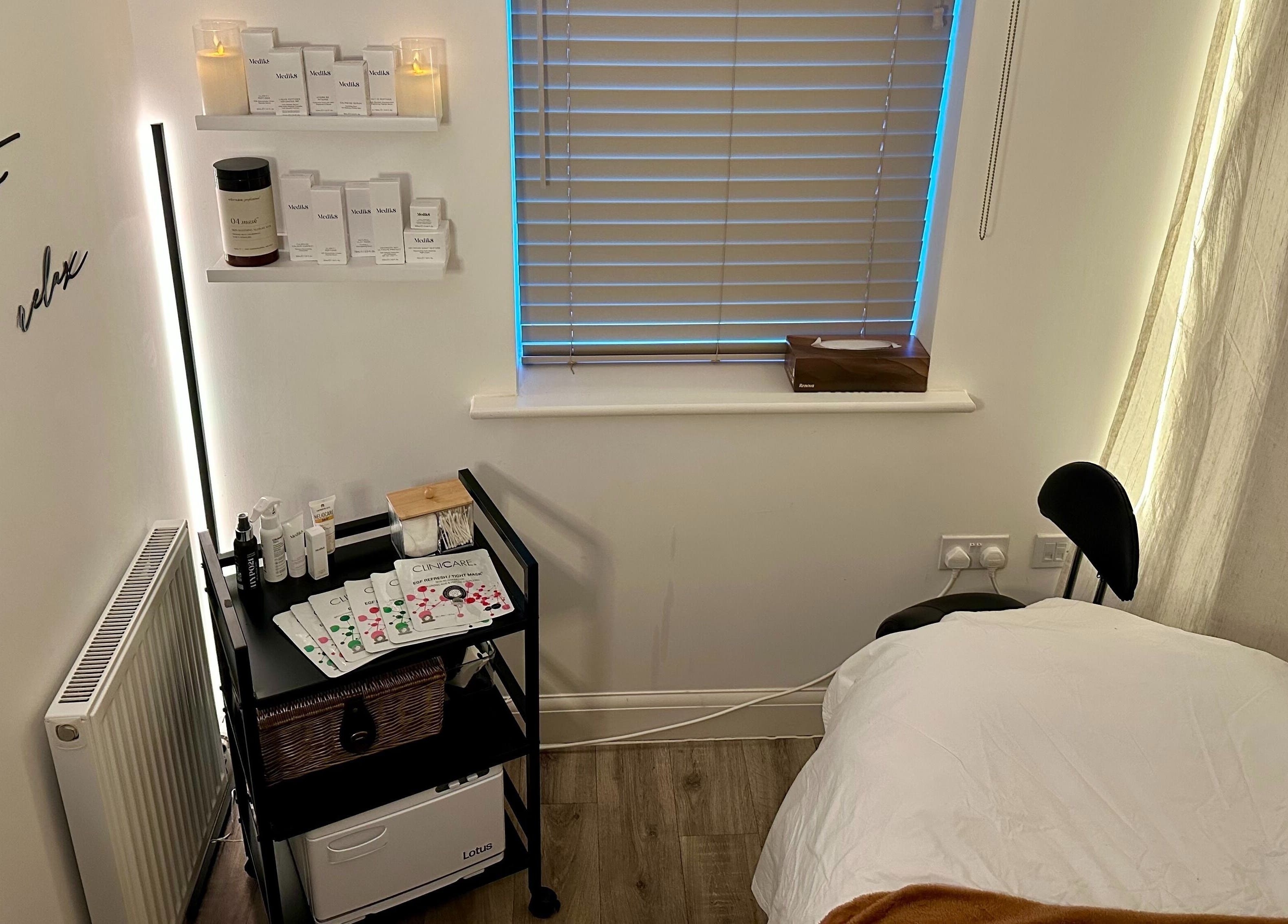 Cozy treatment room at The Skincare Snug, Yate, England, GB, decorated with products and inviting bed.