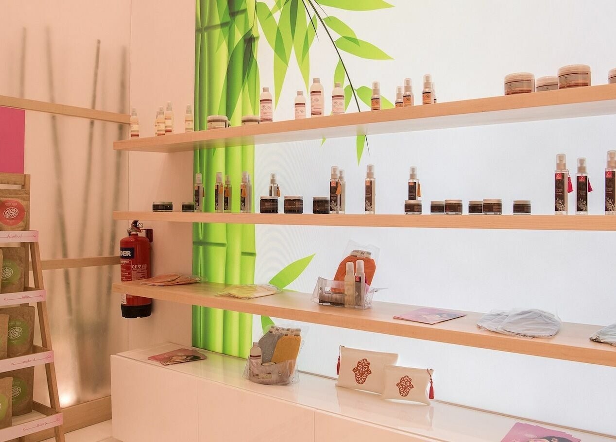 Spa products lined on wooden shelves at Physiomins Beauty Lounge Al Forsan Branch, Abu Dhabi, Abu Dhabi, AE.
