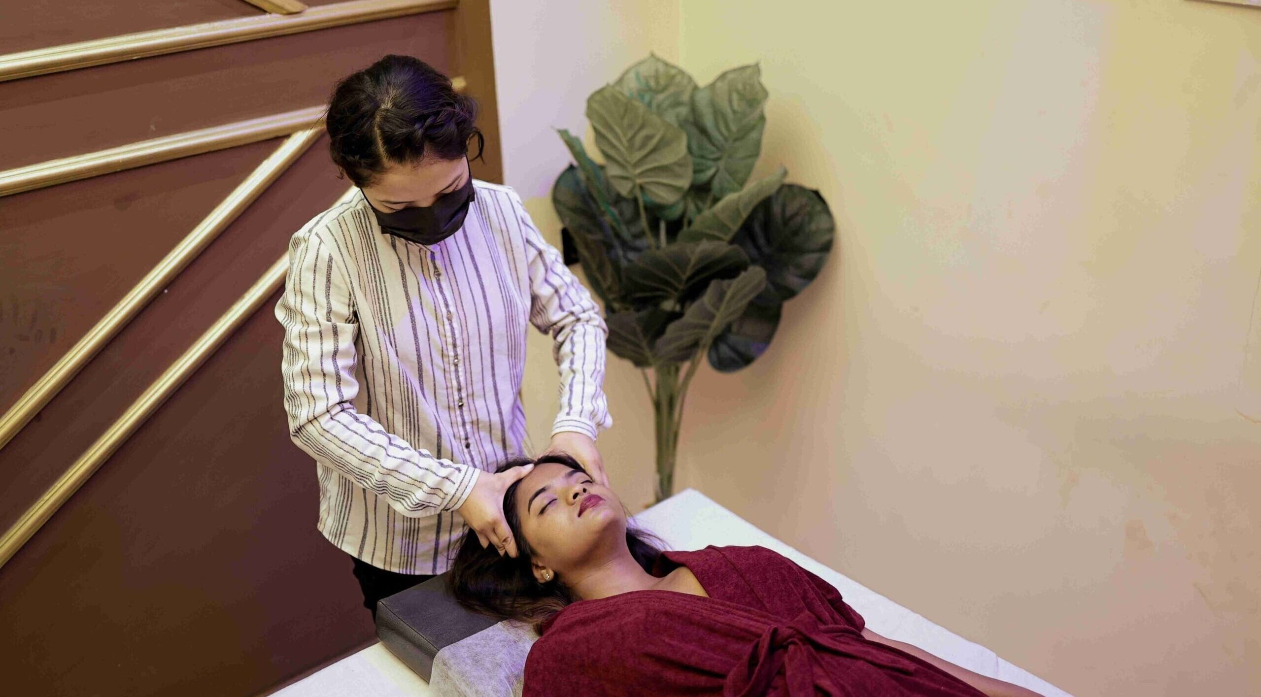 Therapist giving head massage at Blue Lounge Spa Kolathur, Chennai, Tamil Nadu, IN.