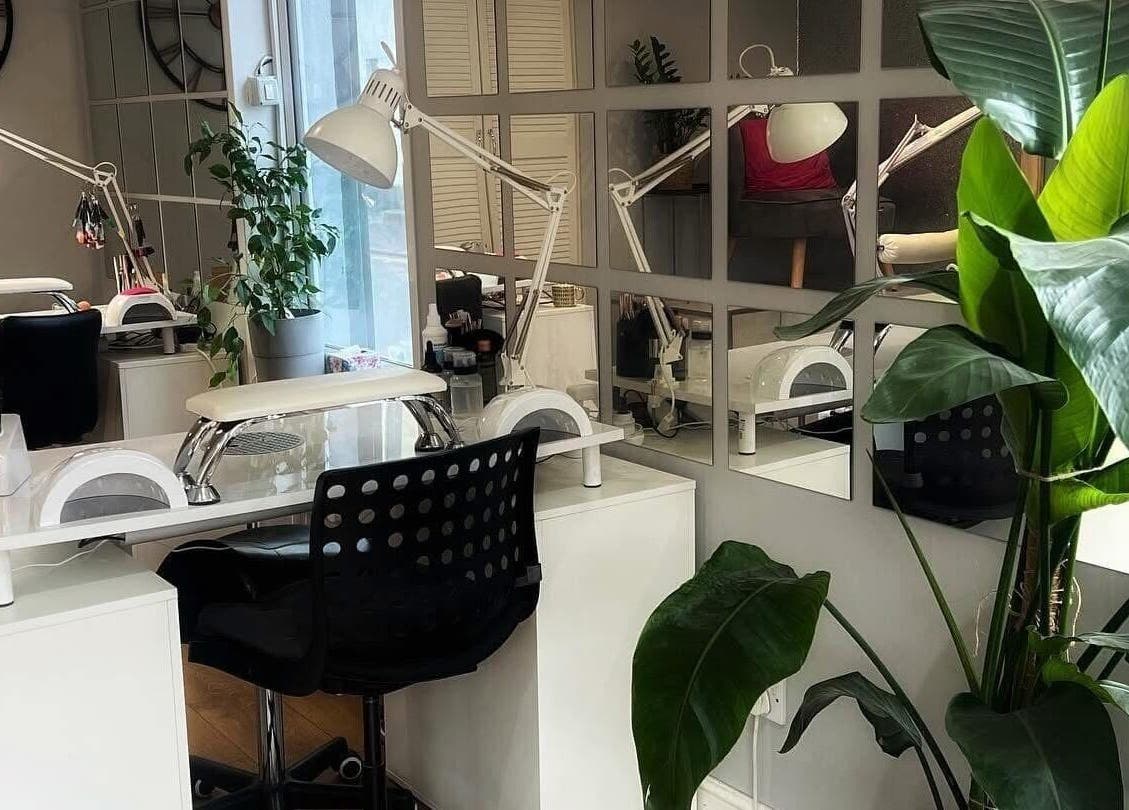 Modern nail salon workspace at Archnailgel, Swindon, England, GB with stylish decor and greenery.