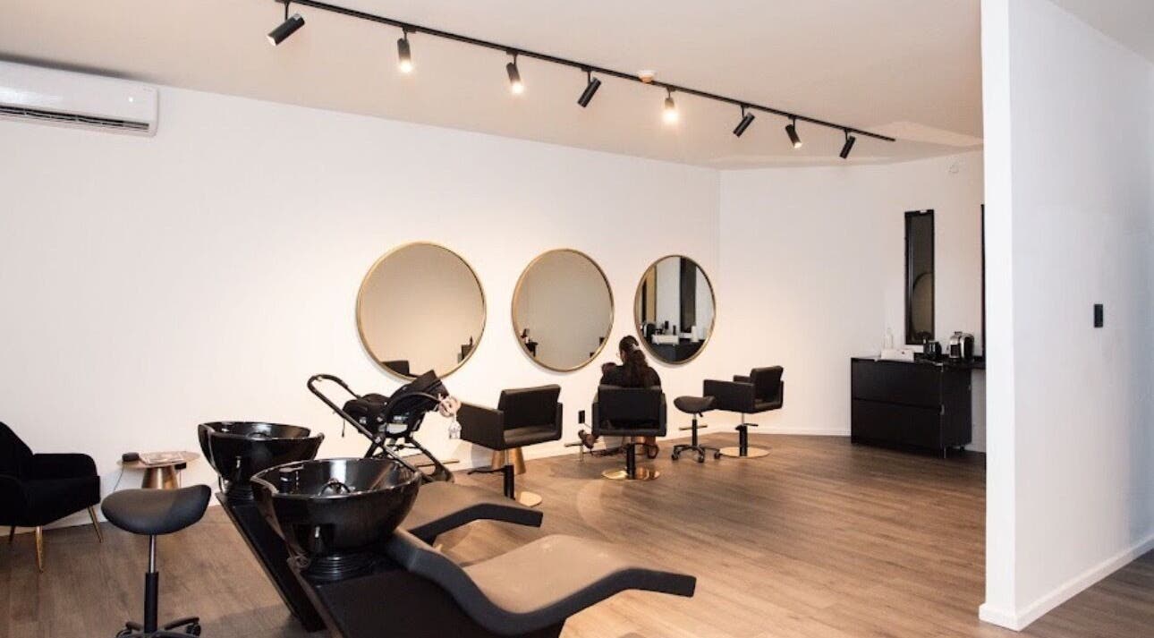 Spacious modern salon at Delete Beauty Lounge, Paramaribo, Paramaribo, SR, featuring elegant styling stations.