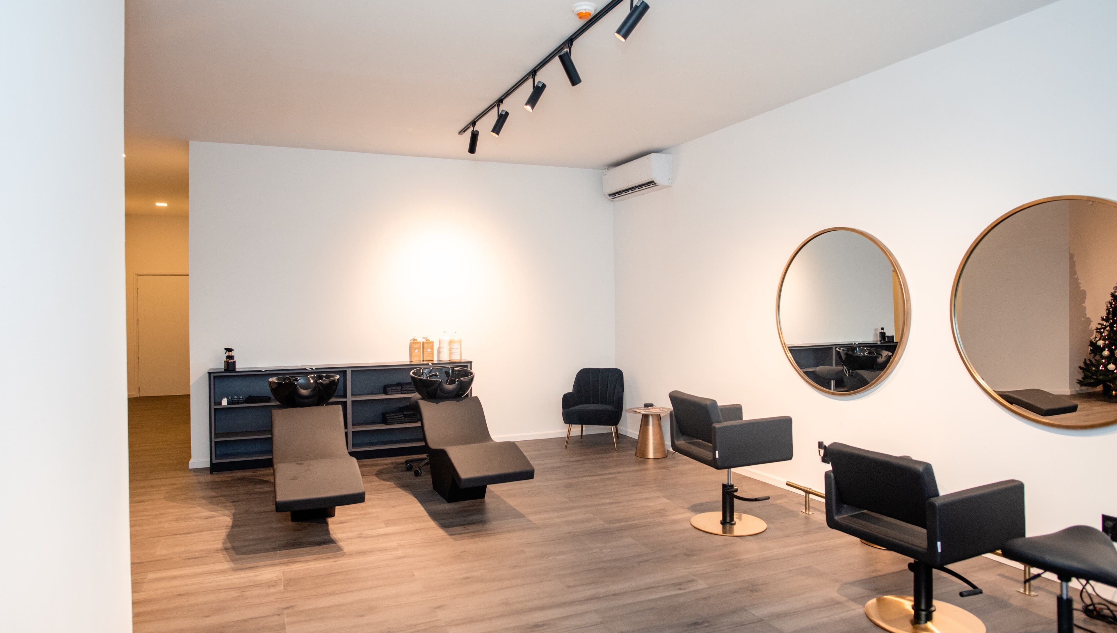 Elegant salon interior at Delete Beauty Lounge in Paramaribo, Paramaribo, SR with modern styling chairs and mirrors.