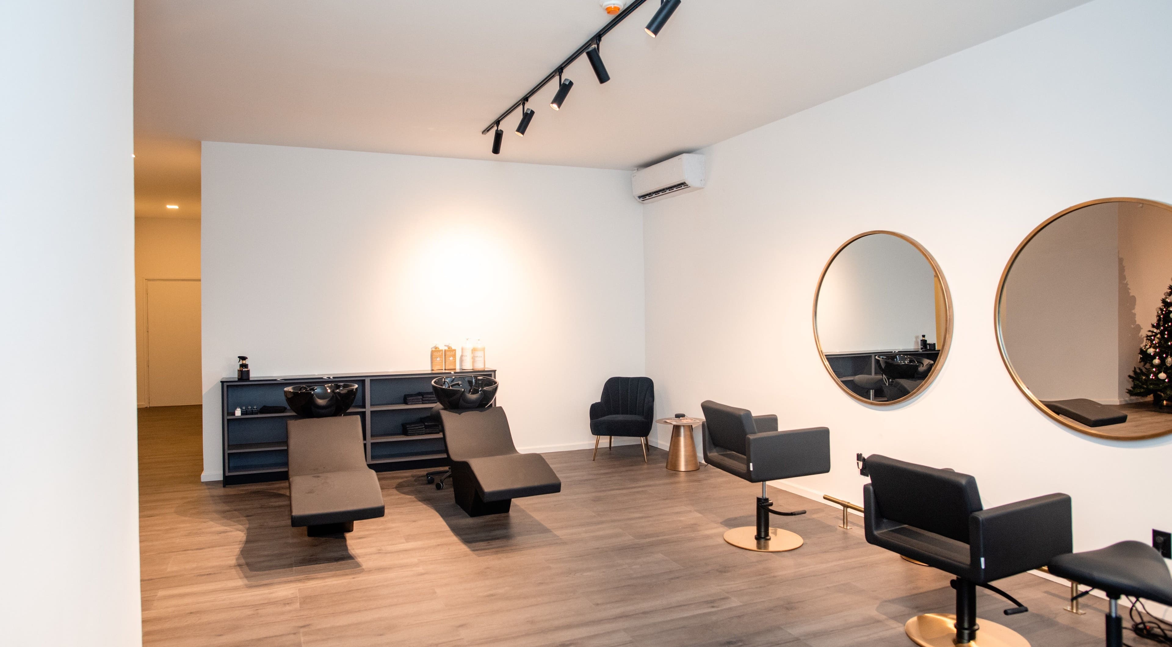 Elegant salon interior at Delete Beauty Lounge in Paramaribo, Paramaribo, SR with modern styling chairs and mirrors.