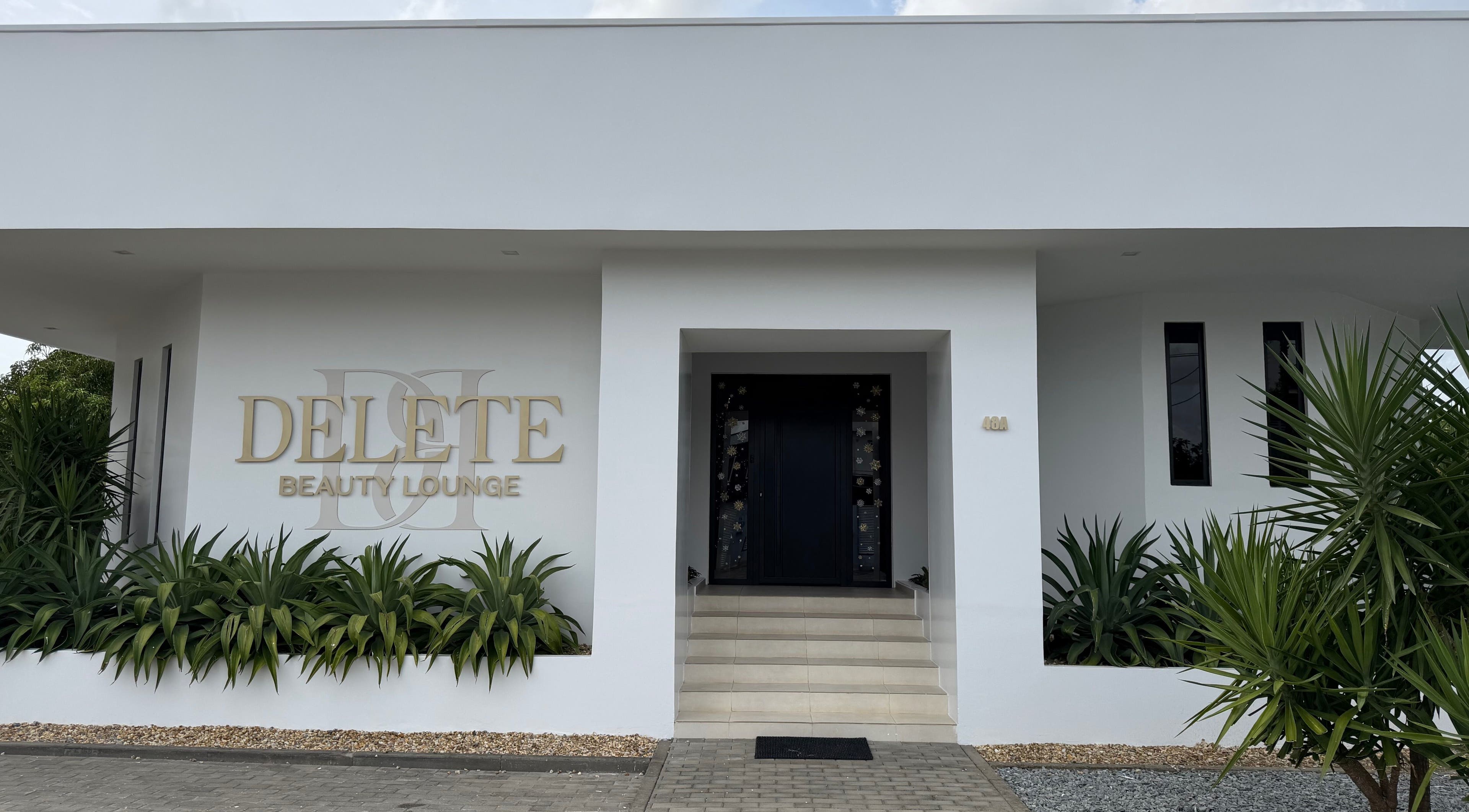 Elegant exterior of Delete Beauty Lounge in Paramaribo, Paramaribo, SR with lush greenery.