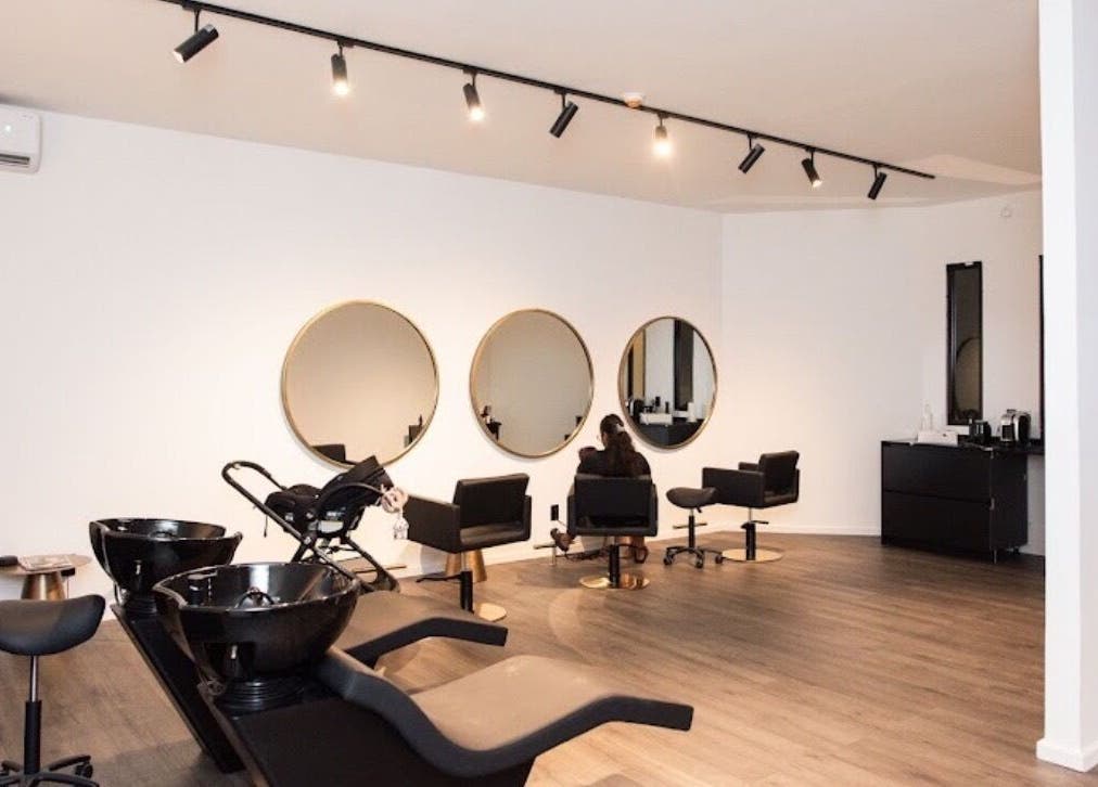 Modern interior of Delete Beauty Lounge, Paramaribo, Paramaribo, SR featuring elegant styling stations.