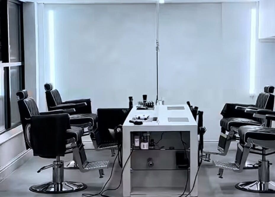Modern barber chairs at M in Da Cut, Manchester, England, GB in a sleek, spacious interior.