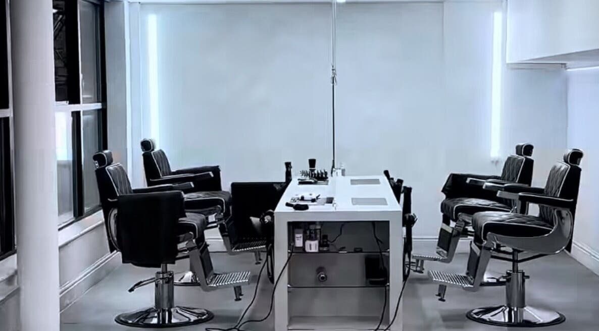 Modern barber chairs at M in Da Cut, Manchester, England, GB in a sleek, spacious interior.