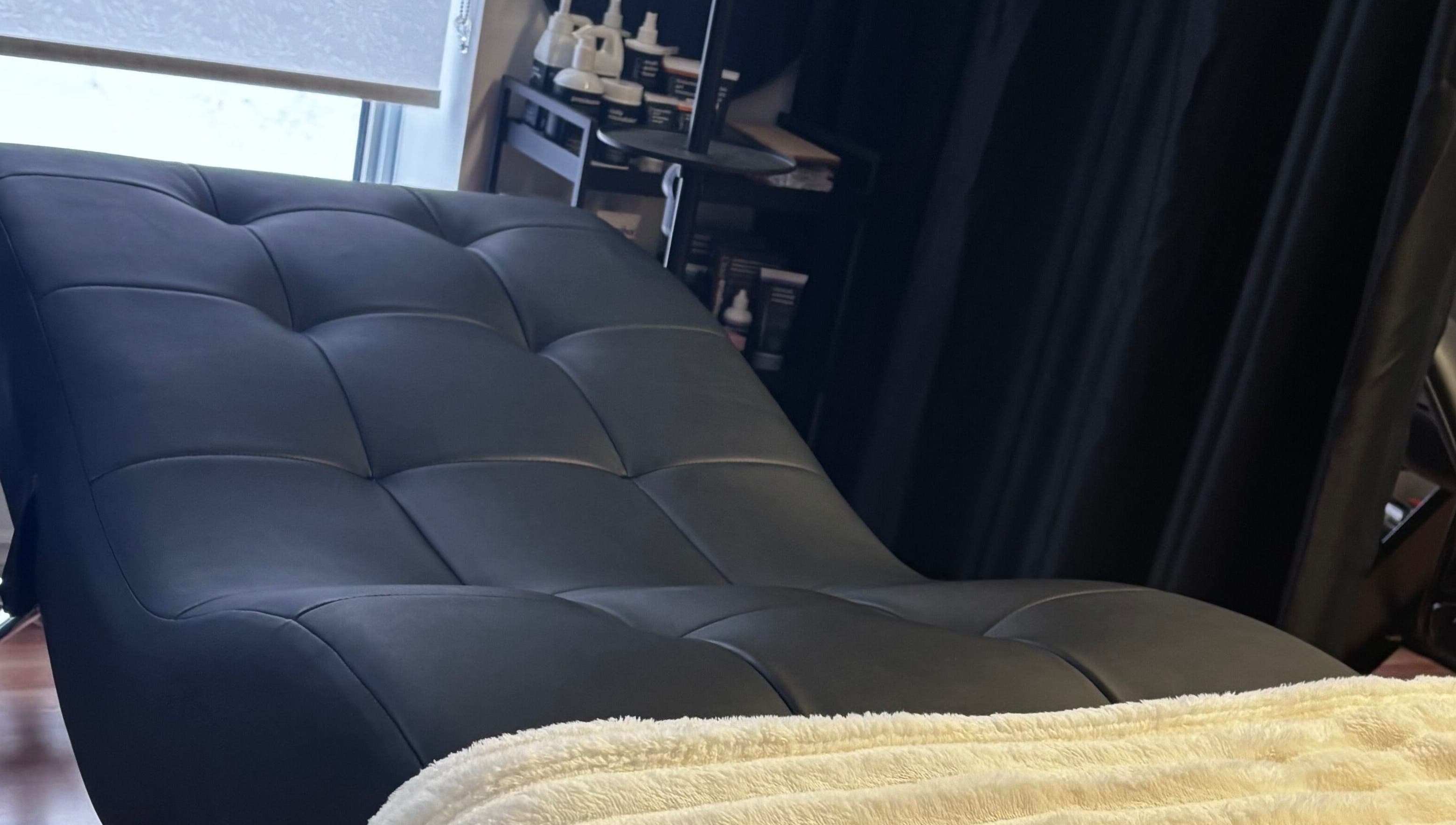 Cozy treatment bed at Aesthetics By Abbey, Gatineau, Québec, CA, inviting relaxation and comfort.