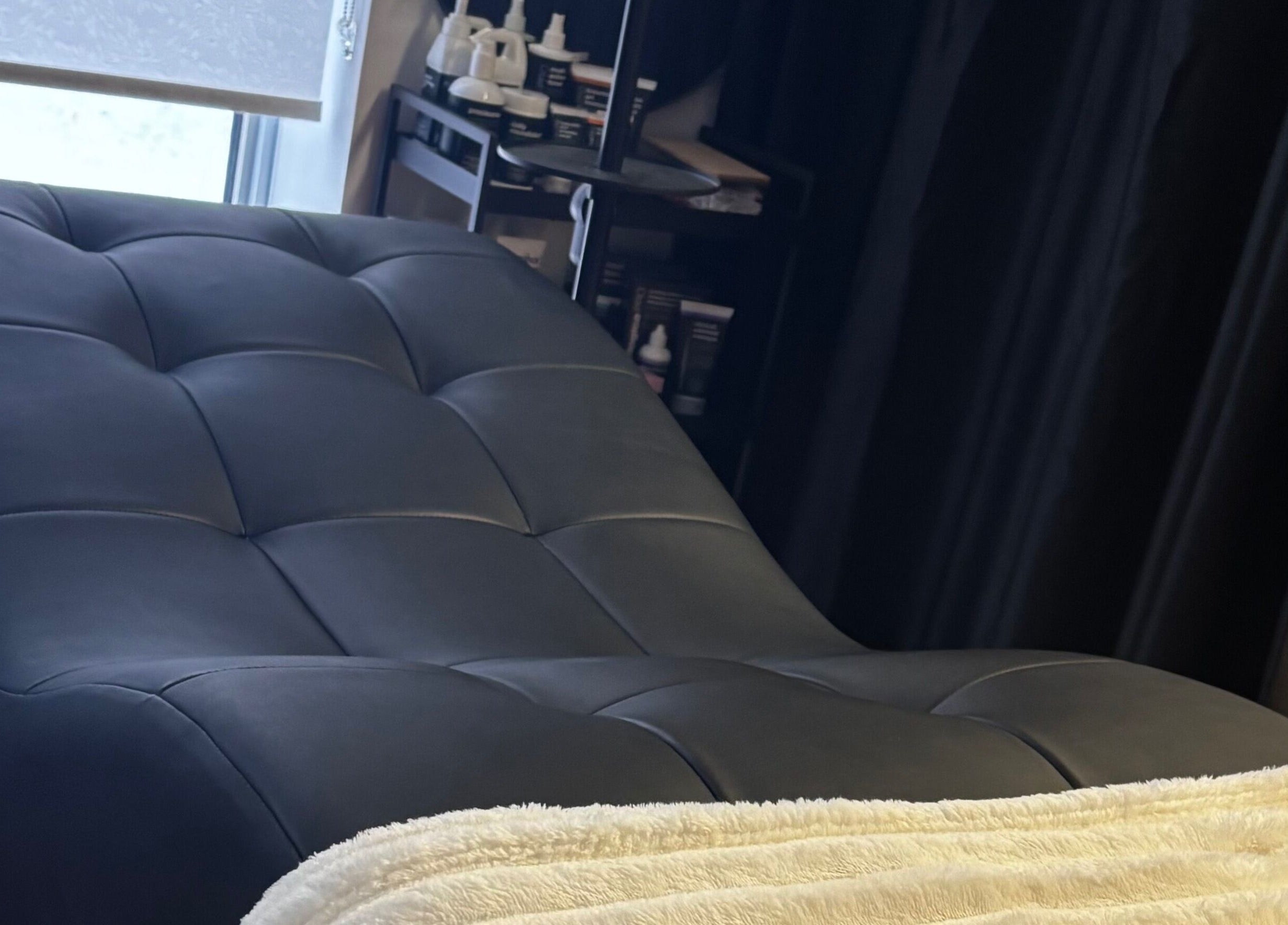 Cozy treatment bed at Aesthetics By Abbey, Gatineau, Québec, CA, inviting relaxation and comfort.