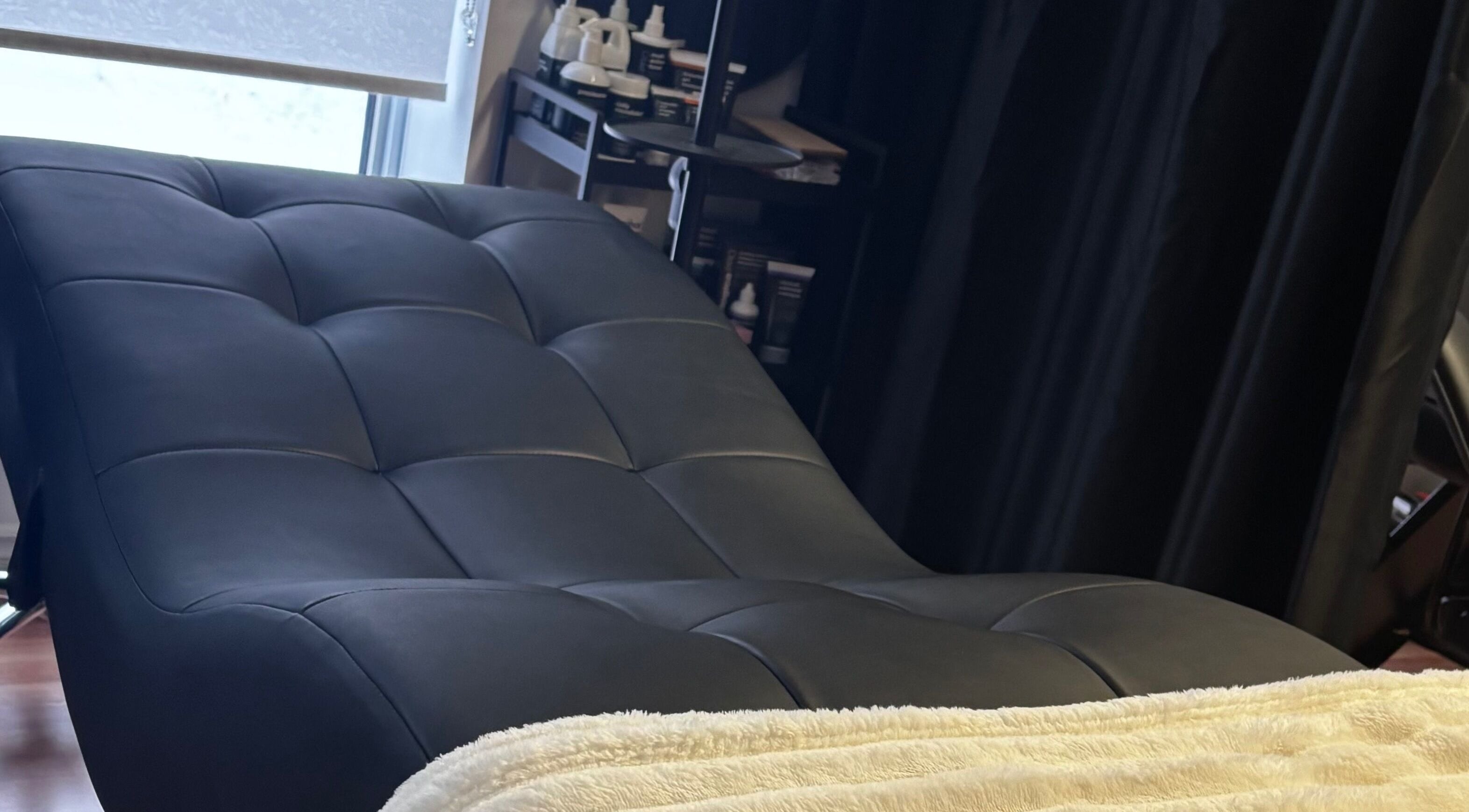 Cozy treatment bed at Aesthetics By Abbey, Gatineau, Québec, CA, inviting relaxation and comfort.