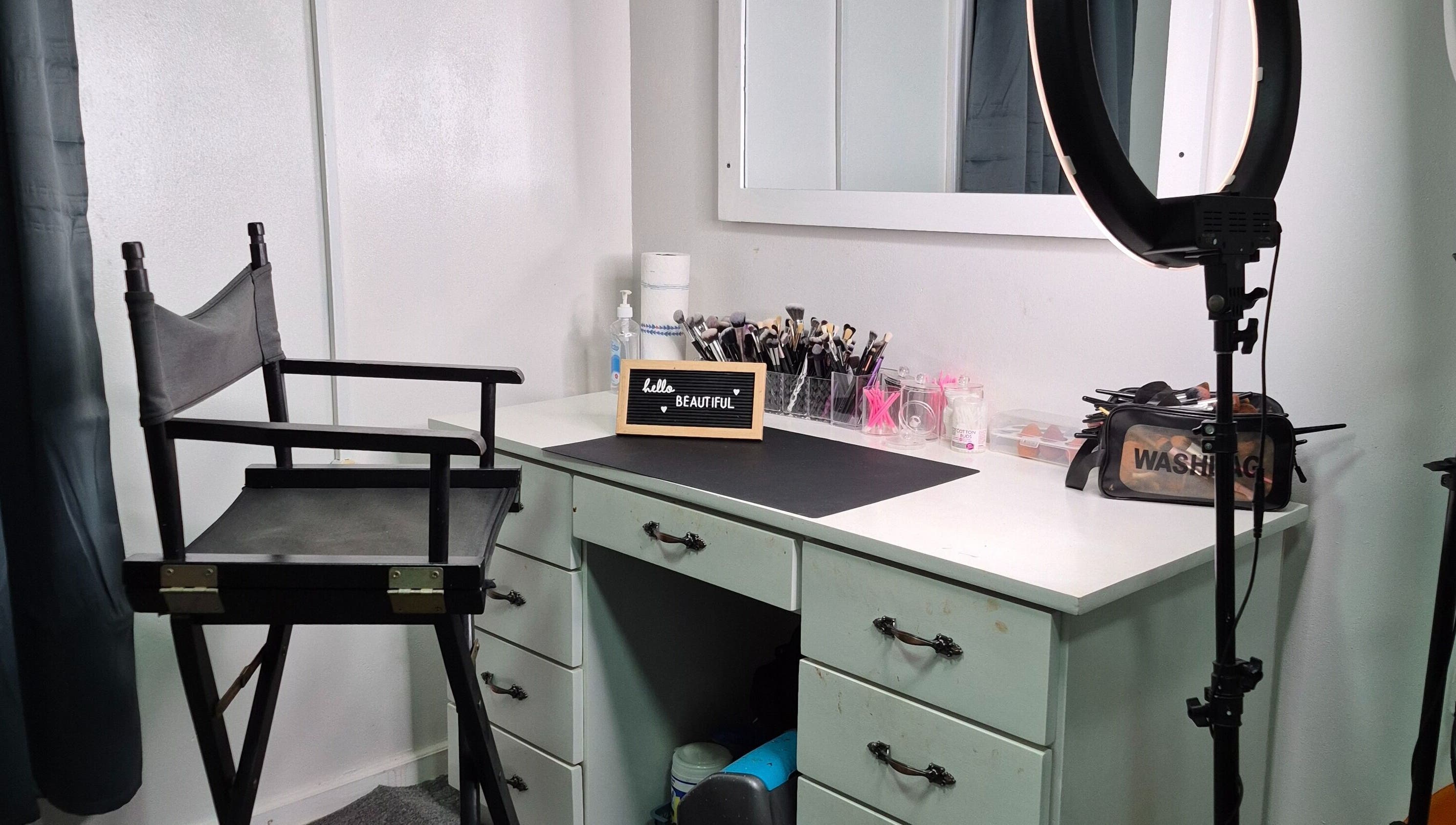 Chic makeup station at Exotic Beats Makeup Studio, Georgetown, GY, with chair, ring light, and cosmetics.