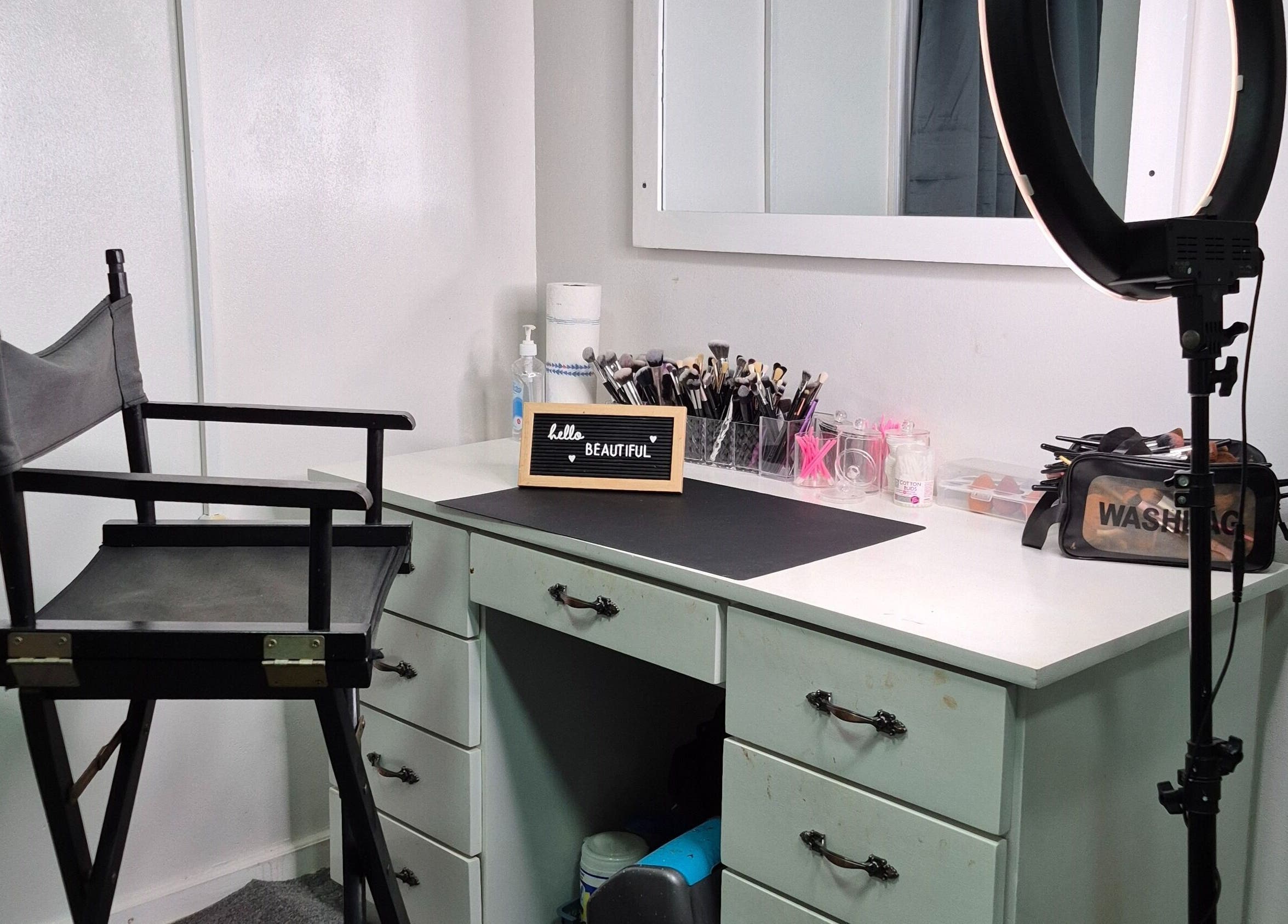 Chic makeup station at Exotic Beats Makeup Studio, Georgetown, GY, with chair, ring light, and cosmetics.