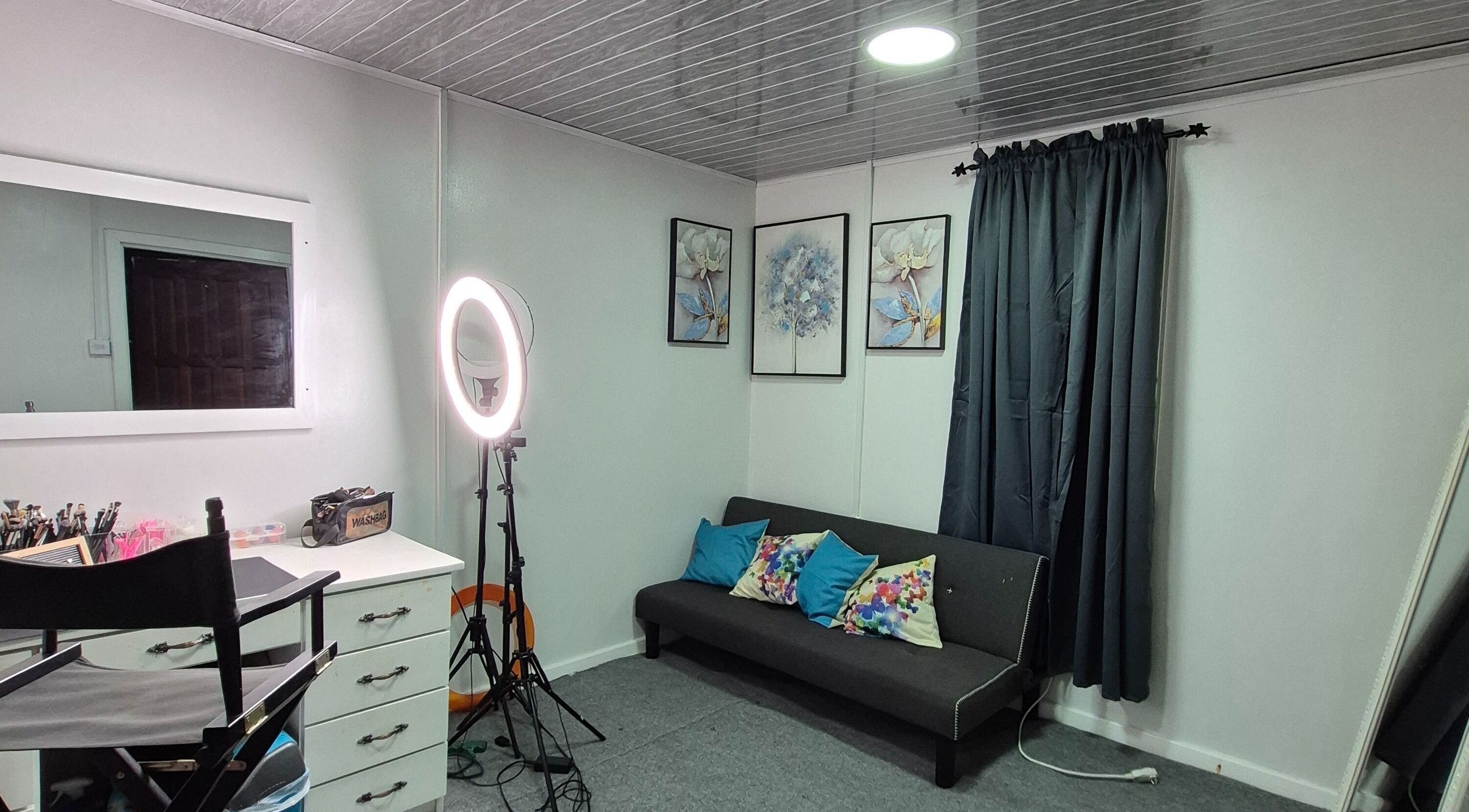 Bright makeup station at Exotic Beats Makeup Studio, Georgetown, GY, with ring light and art decor.