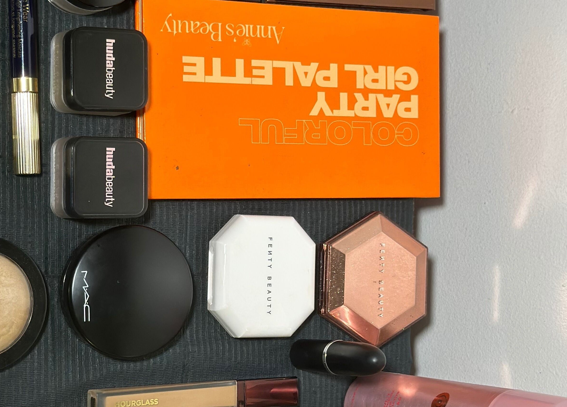 Diverse makeup collection at Efoma’s Touch Artistry, Birmingham, England, GB, showcasing luxury brands.