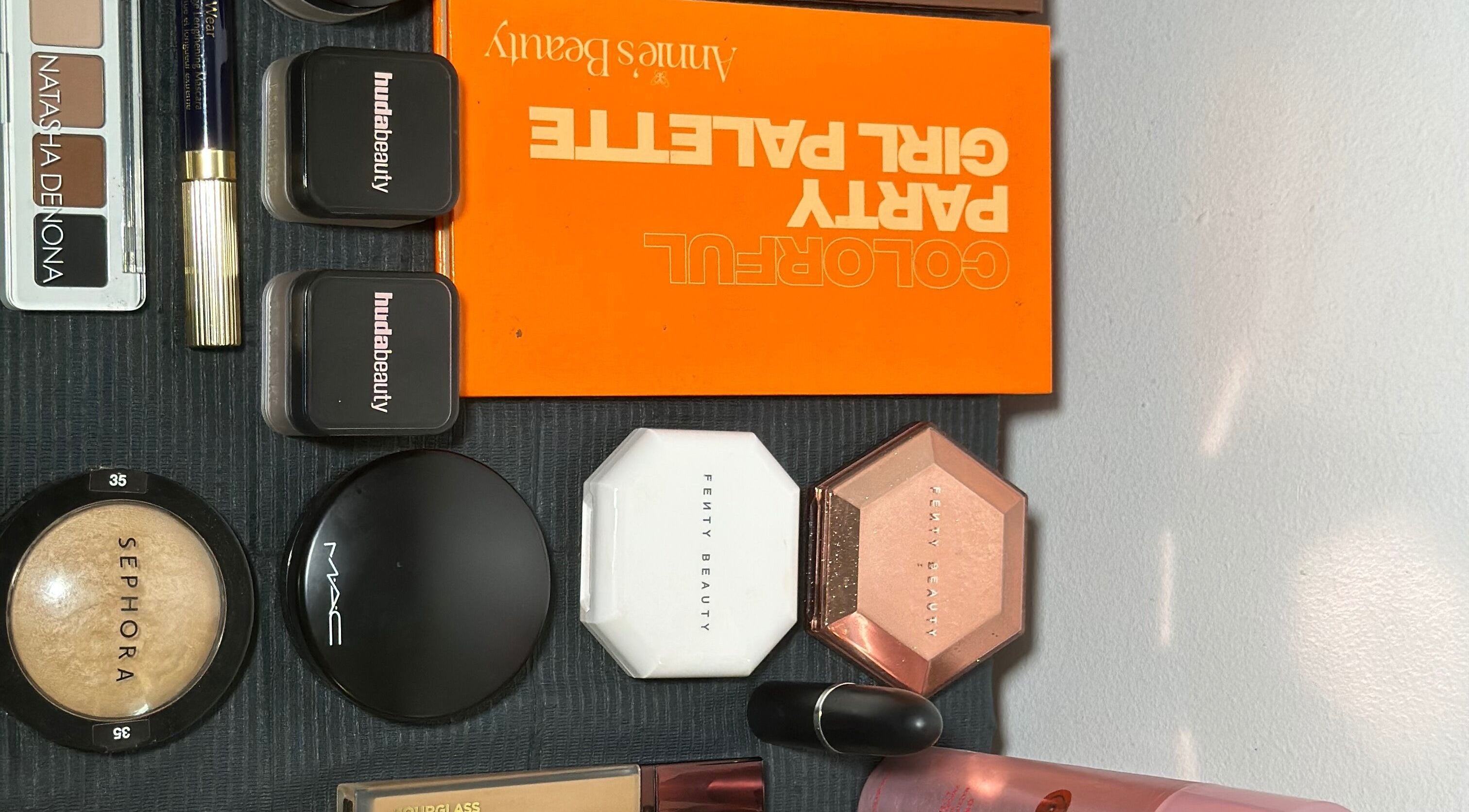 Diverse makeup collection at Efoma’s Touch Artistry, Birmingham, England, GB, showcasing luxury brands.