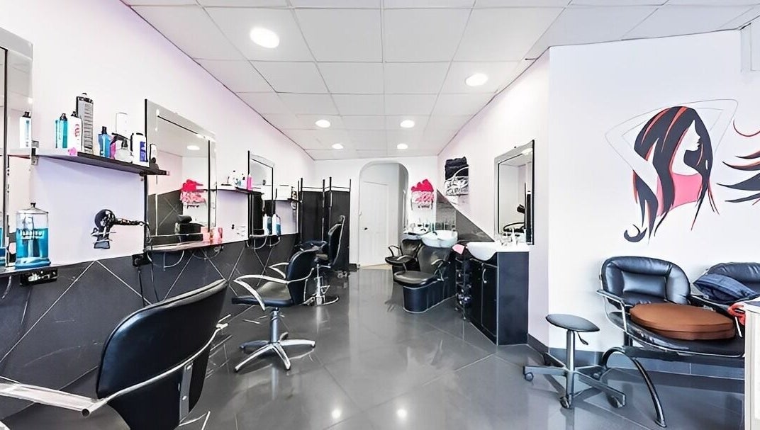Modern salon interior at XPRESSIONS HAIR & BEAUTY LTD, Hayes, England, GB, showcasing sleek styling stations.
