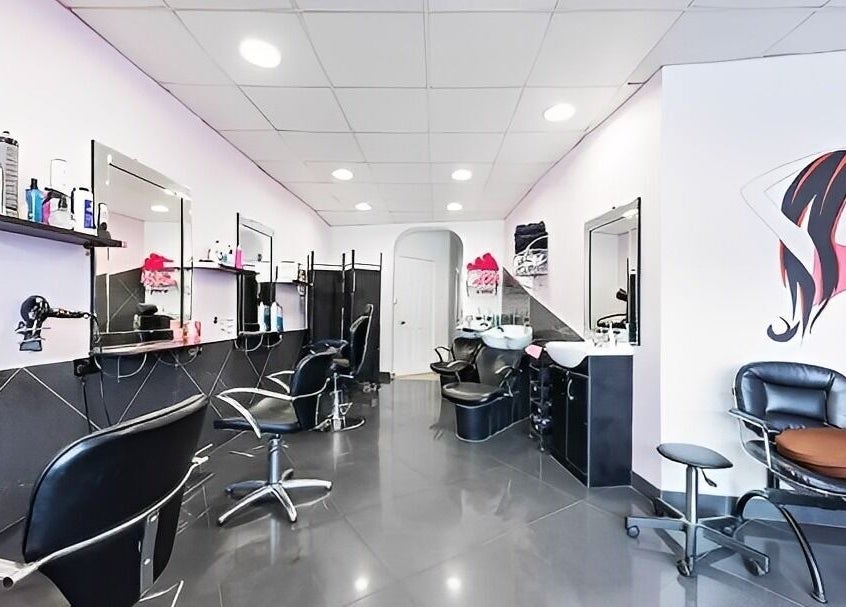 Modern salon interior at XPRESSIONS HAIR & BEAUTY LTD, Hayes, England, GB, showcasing sleek styling stations.