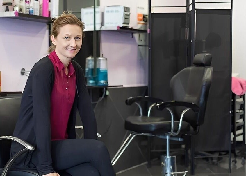 Professional stylist at XPRESSIONS HAIR & BEAUTY LTD in Hayes, England, GB inside the modern salon.