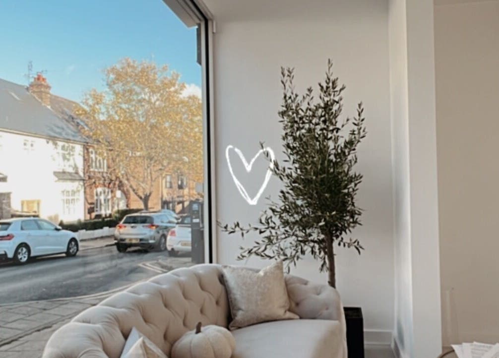 Elegant lounge area at Aura Skinn By Sandra in Buckhurst Hill, England, GB with large window view.